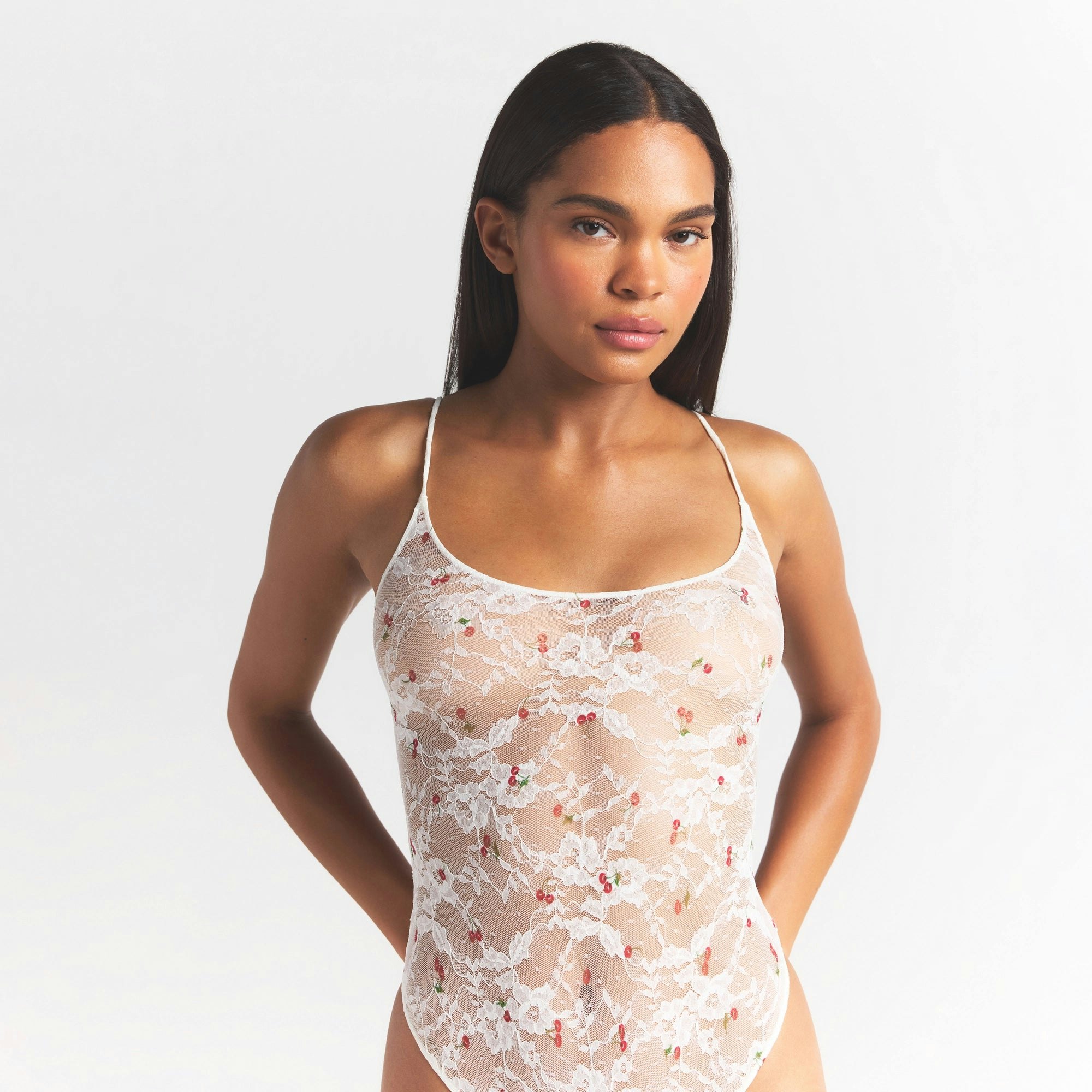 STRETCH LACE THONG BODYSUIT | IVORY CHERRY PRINT ON A MODEL SIDE VIEW @ | FOCUS: 0.0, 1.0, 0.9