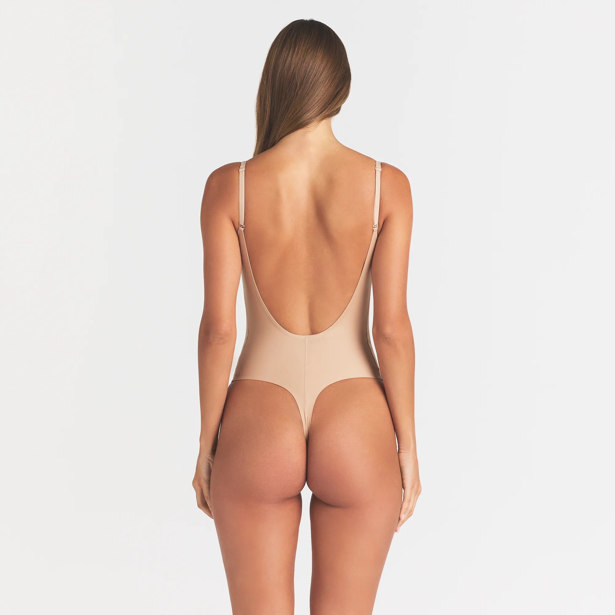 SKIMS BODY SCOOP LOW BACK THONG BODYSUIT | CLAY ON A MODEL BACK VIEW @ | FOCUS: 0.0, 1.0, 0.9