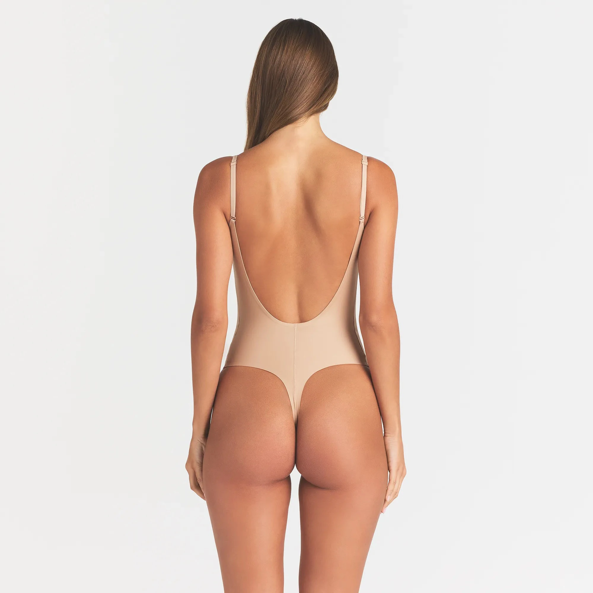 SKIMS BODY SCOOP LOW BACK THONG BODYSUIT | CLAY ON A MODEL BACK VIEW @ | FOCUS: 0.0, 1.0, 0.9