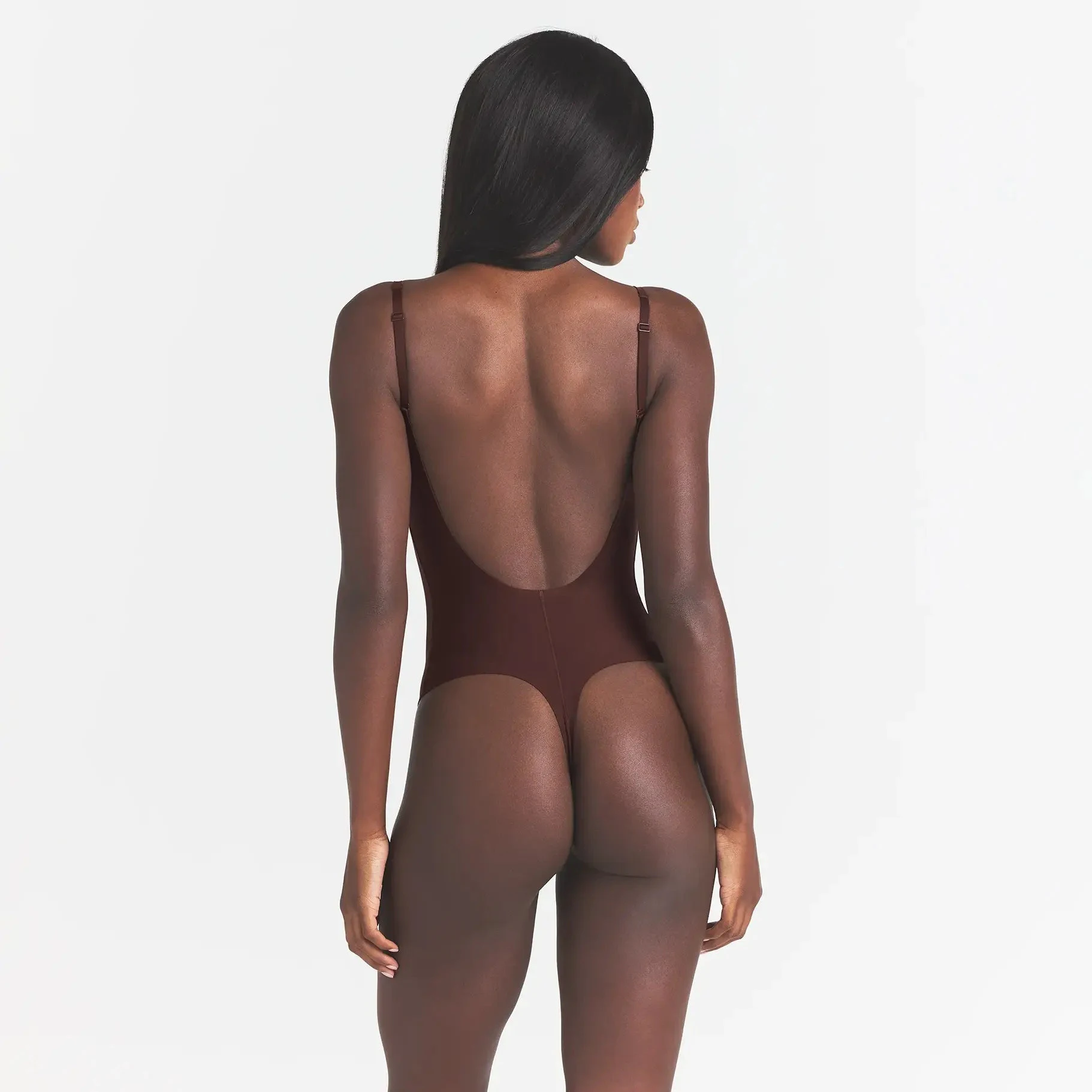 SKIMS BODY SCOOP LOW BACK THONG BODYSUIT | COCOA ON A MODEL BACK VIEW @ | FOCUS: 0.0, 1.0, 0.9
