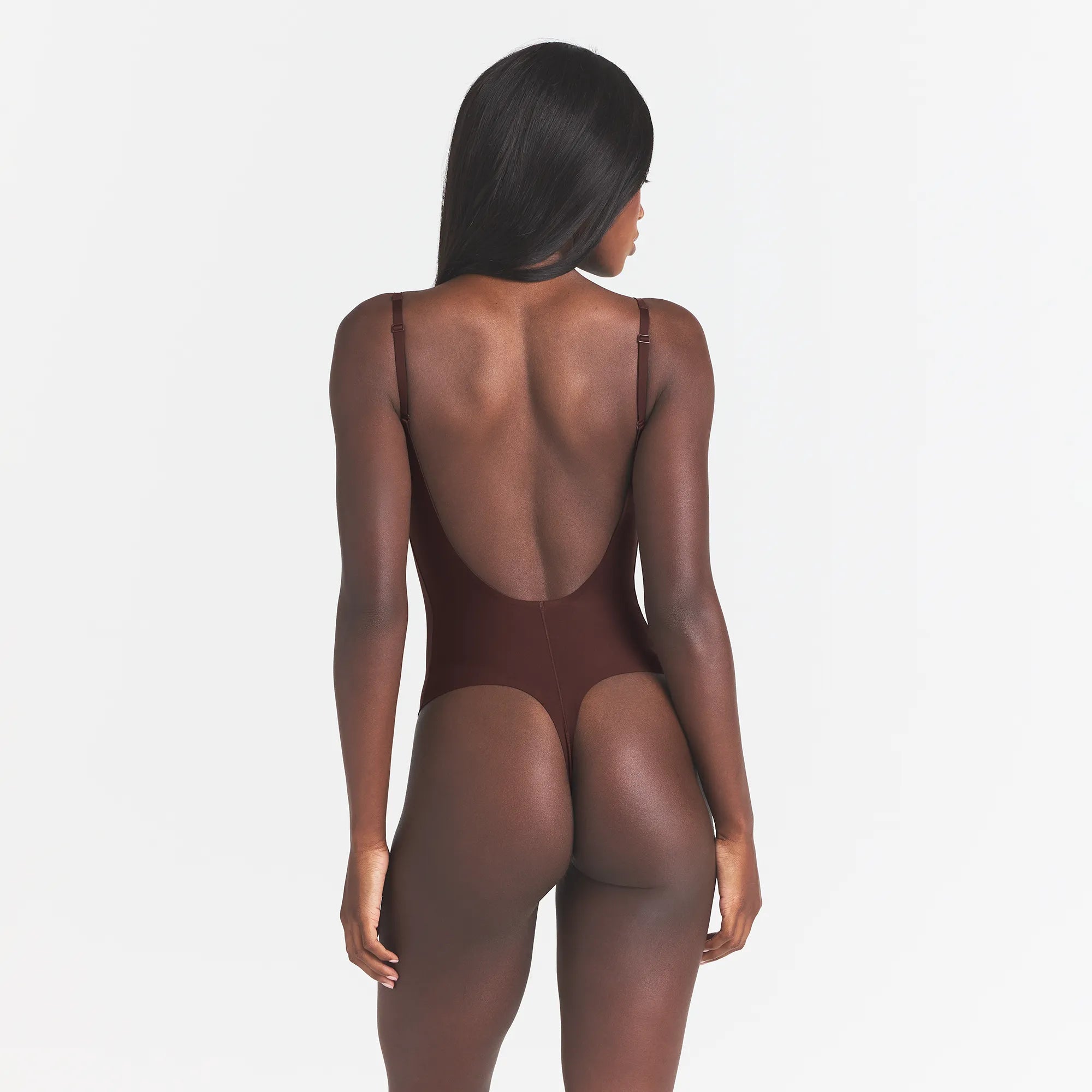 SKIMS BODY SCOOP LOW BACK THONG BODYSUIT | COCOA ON A MODEL BACK VIEW @