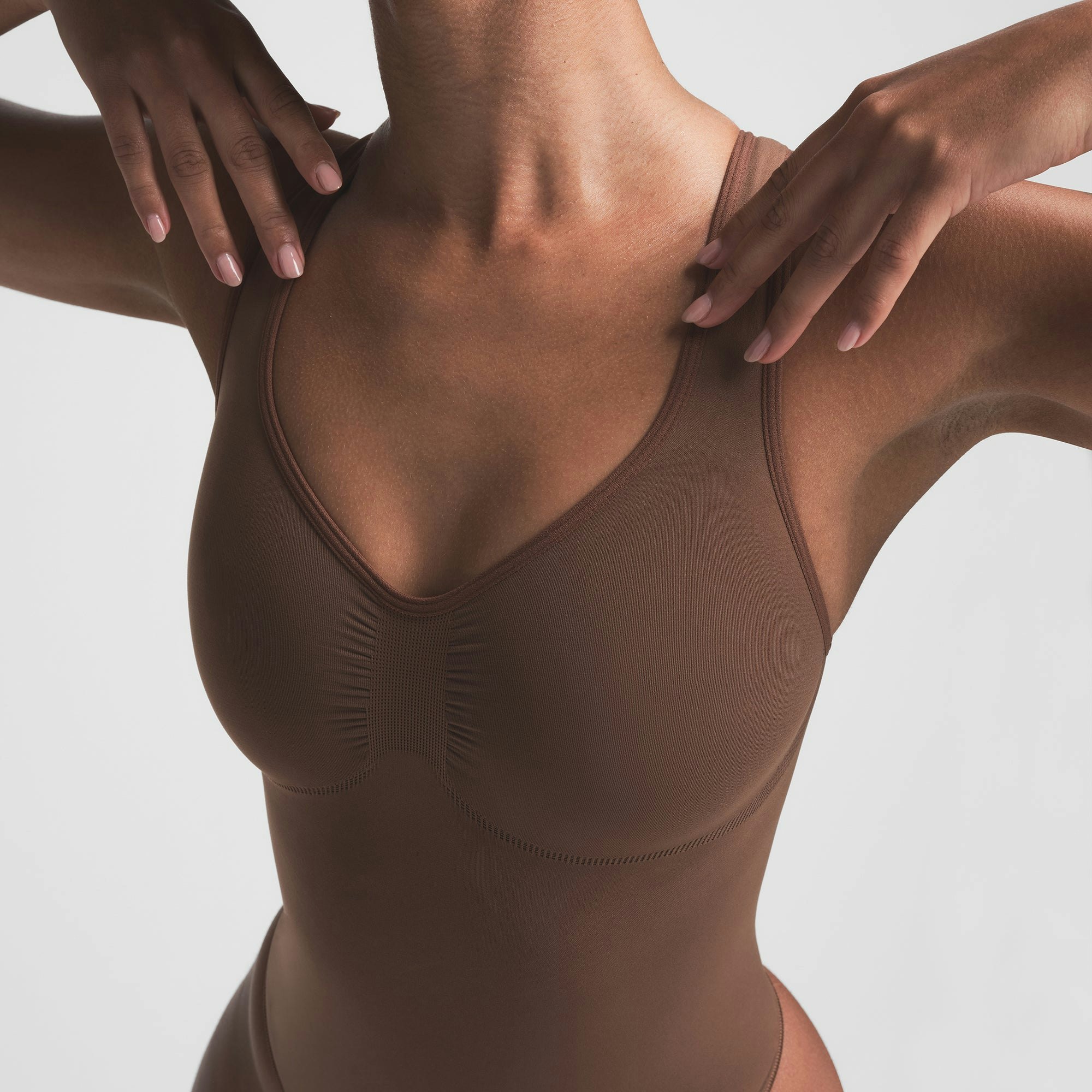 SEAMLESS SCULPT SCOOP NECK THONG BODYSUIT | JASPER ON A MODEL FRONT VIEW | FOCUS: 0.0, 1.0, 0.9