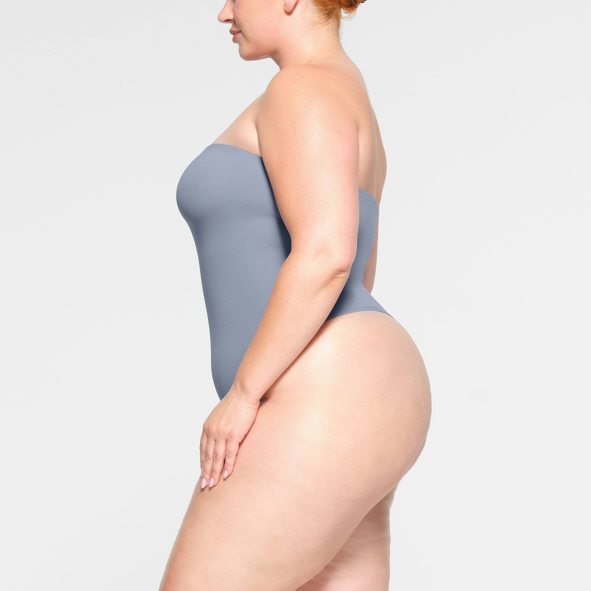 FITS EVERYBODY STRAPLESS BODYSUIT WORN BY A MODEL IN SIDE VIEW