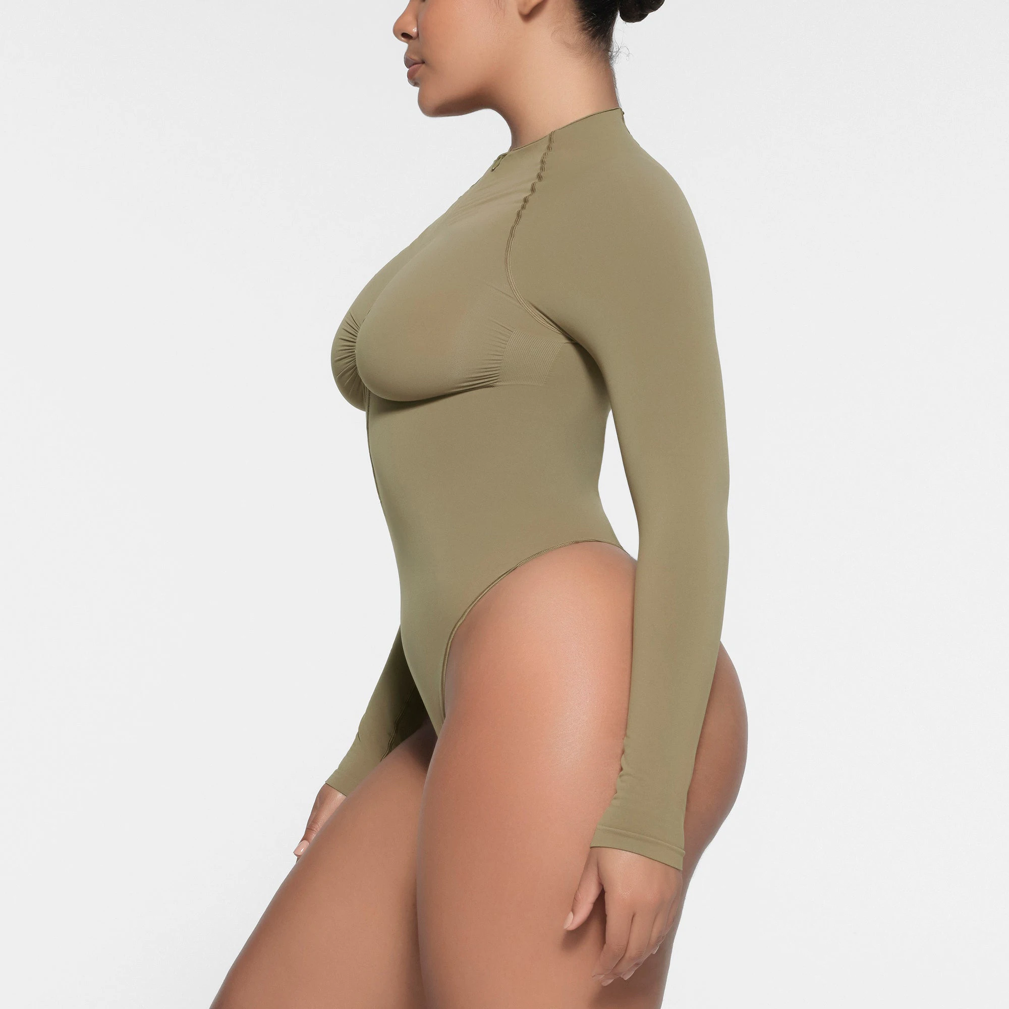 SEAMLESS SCULPT HALF ZIP LONG SLEEVE THONG BODYSUIT | ARMY ON A MODEL SIDE VIEW