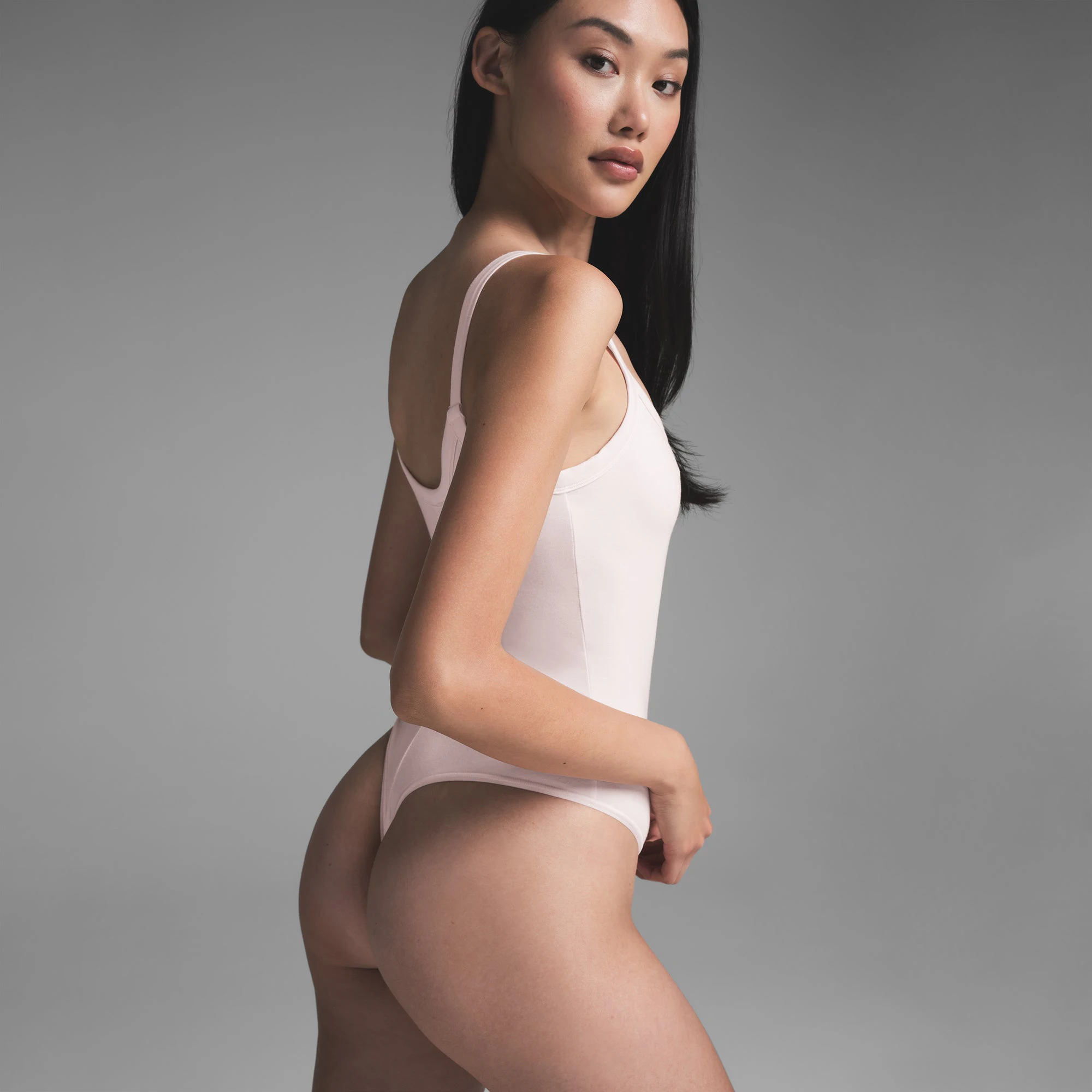 COTTON JERSEY SCOOP NECK BODYSUIT | BARELY PINK ON A MODEL SIDE VIEW | FOCUS: 0.0, 1.0, 0.9