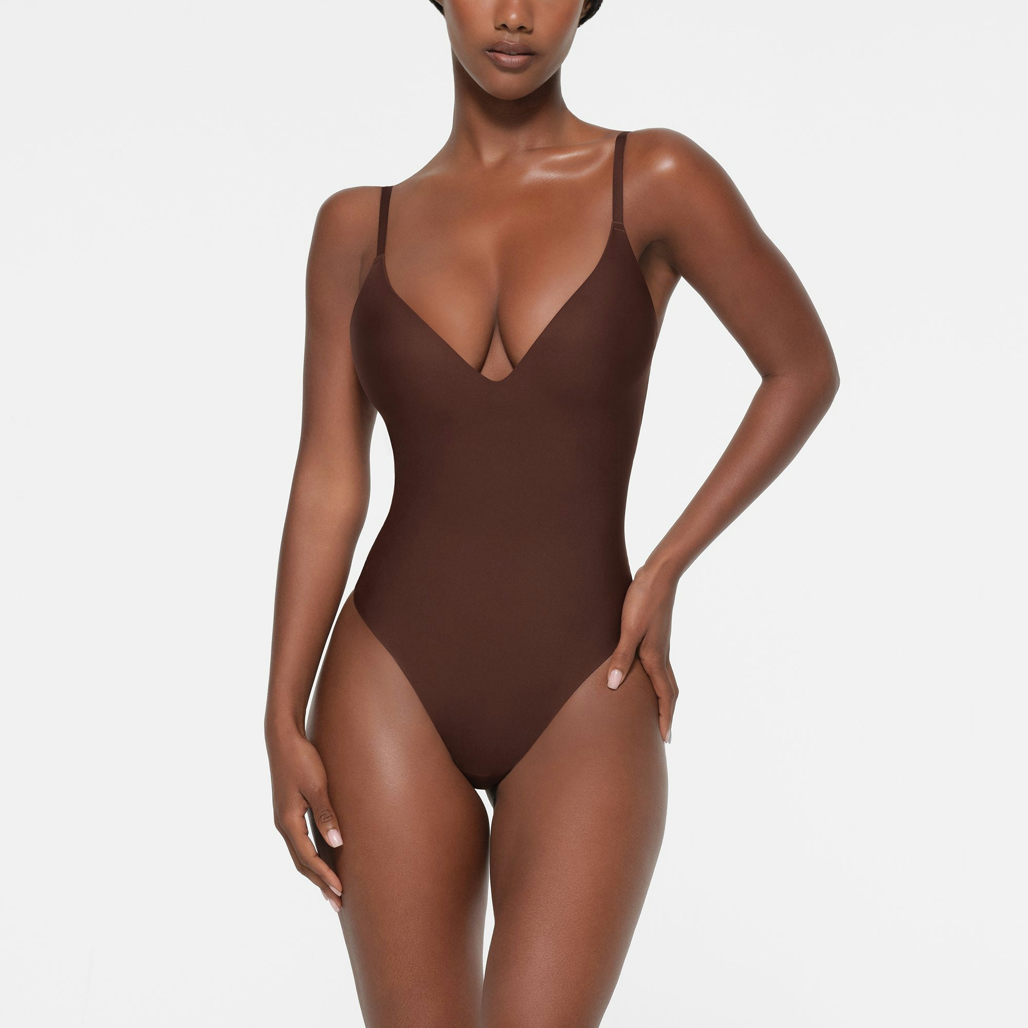 SKIMS BODY PUSH-UP THONG BODYSUIT | COCOA ON A MODEL FRONT VIEW