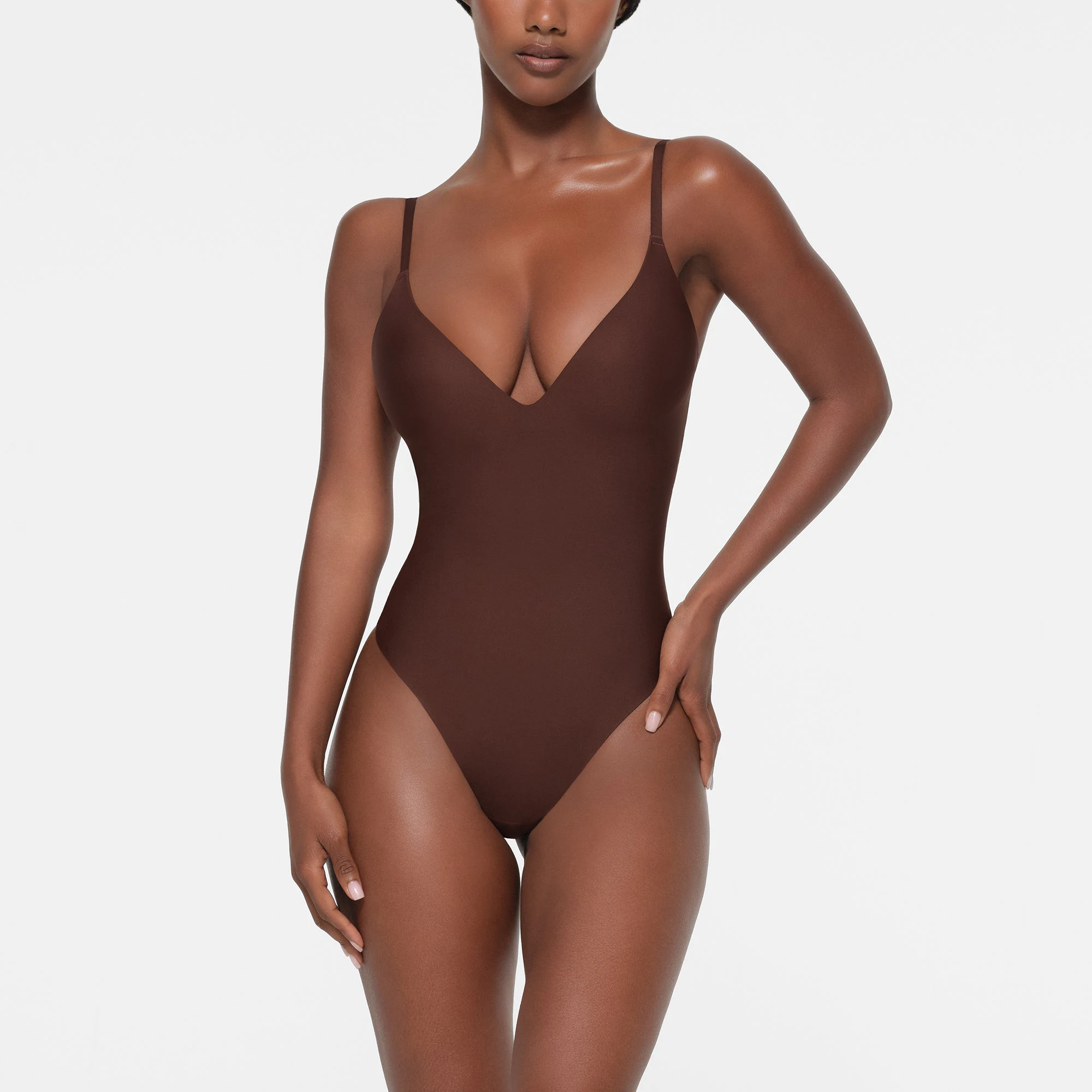 SKIMS BODY PUSH-UP THONG BODYSUIT | COCOA ON A MODEL FRONT VIEW