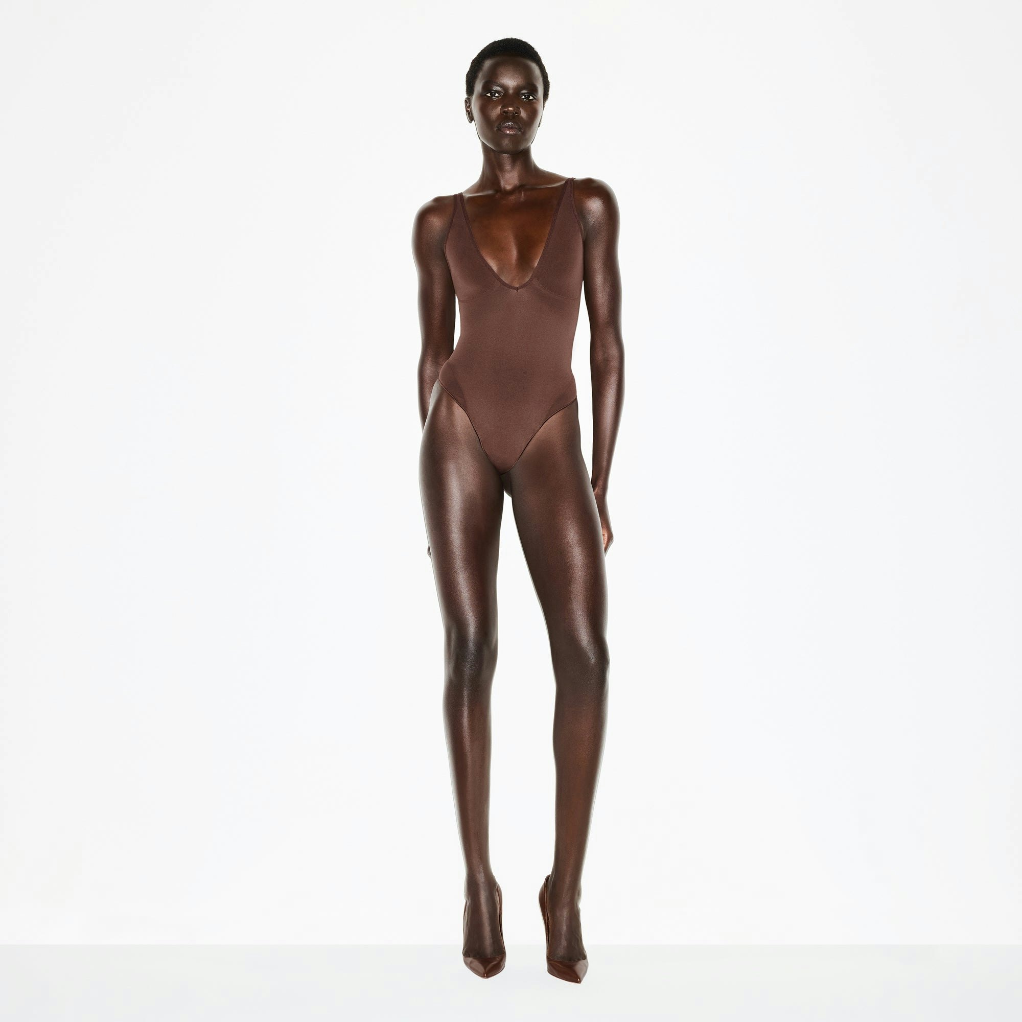 SEAMLESS SCULPT DEEP PLUNGE THONG BODYSUIT | COCOA ON A MODEL FRONT VIEW @ | FOCUS: 0.0, 1.0, 0.9