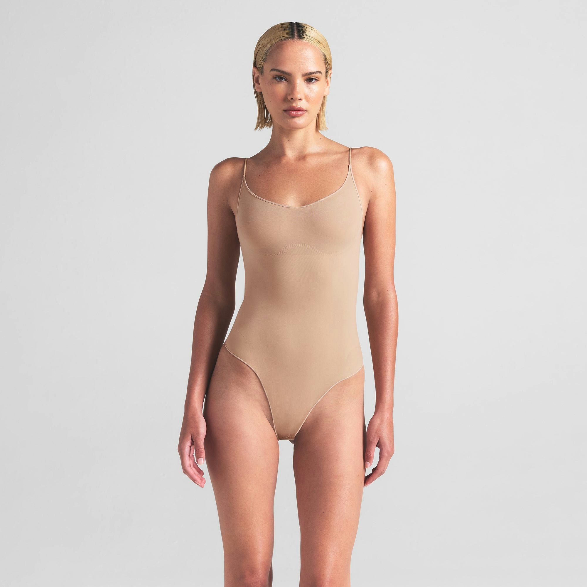 SHEER SEAMLESS THONG BODYSUIT | CLAY ON A MODEL FRONT VIEW | FOCUS: 0.0, 1.0, 0.9