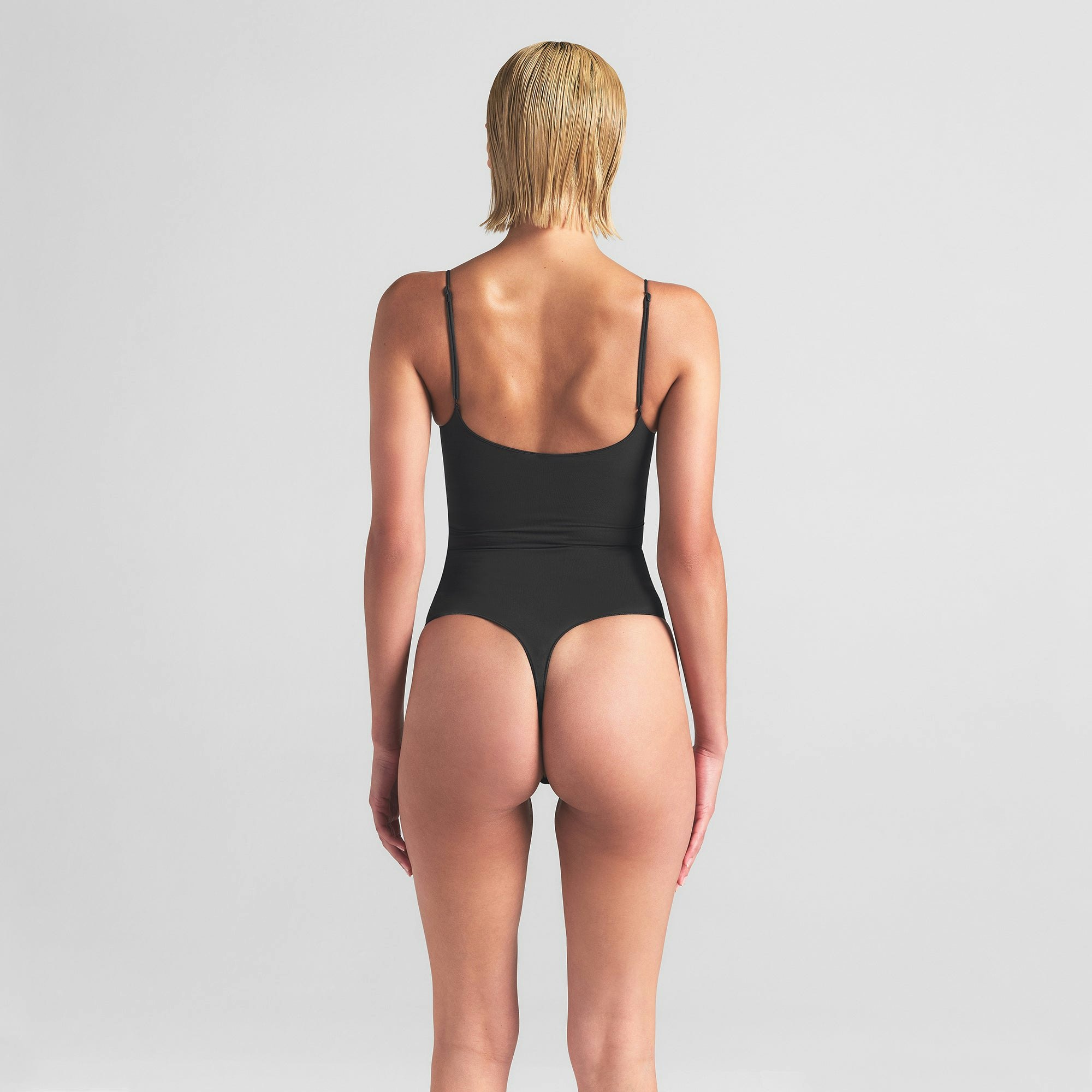SHEER SEAMLESS THONG BODYSUIT | ONYX ON A MODEL BACK VIEW | FOCUS: 0.0, 1.0, 0.9