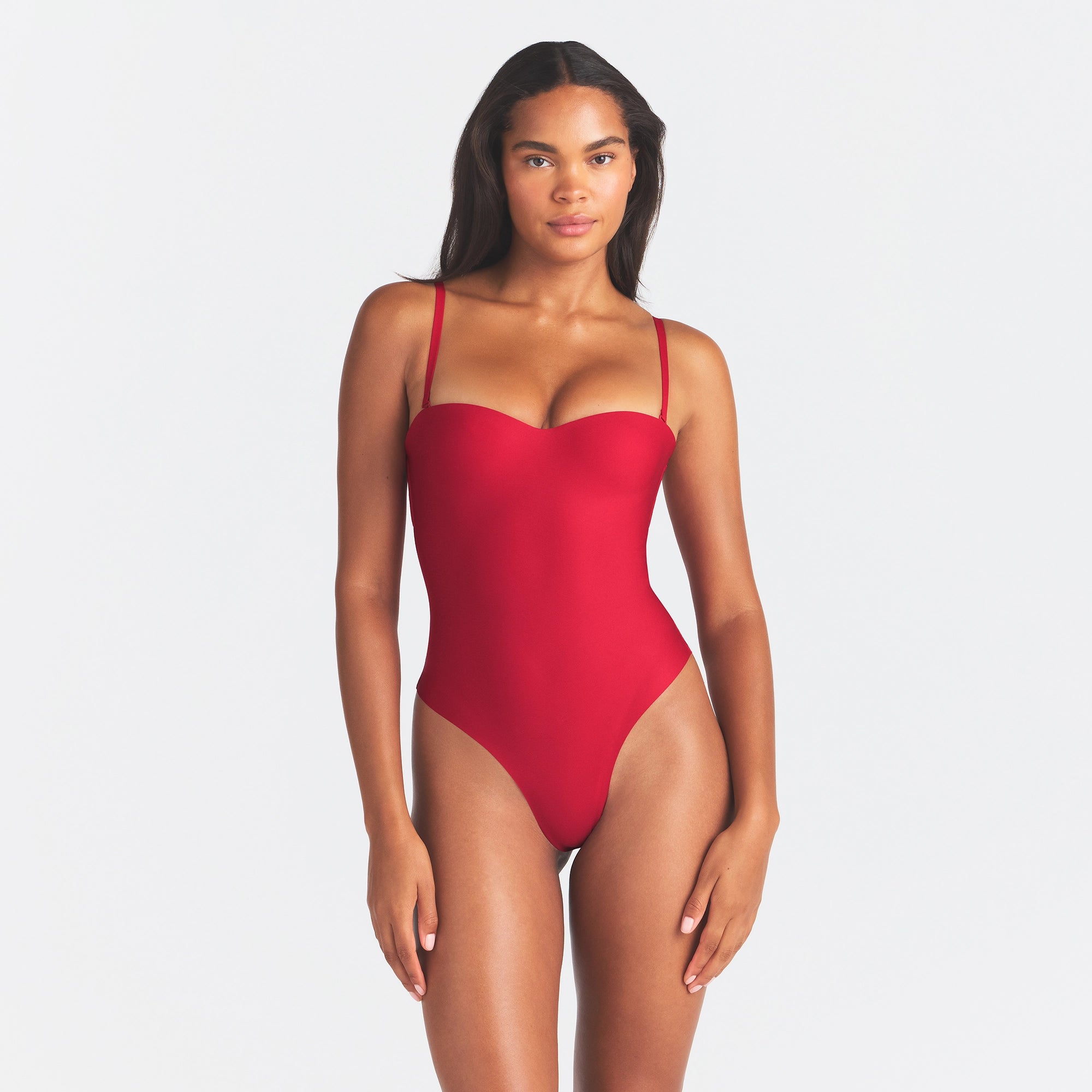 SKIMS BODY UNDERWIRE THONG BODYSUIT | CARDINAL ON A MODEL FRONT VIEW @ | FOCUS: 0.0, 1.0, 0.9