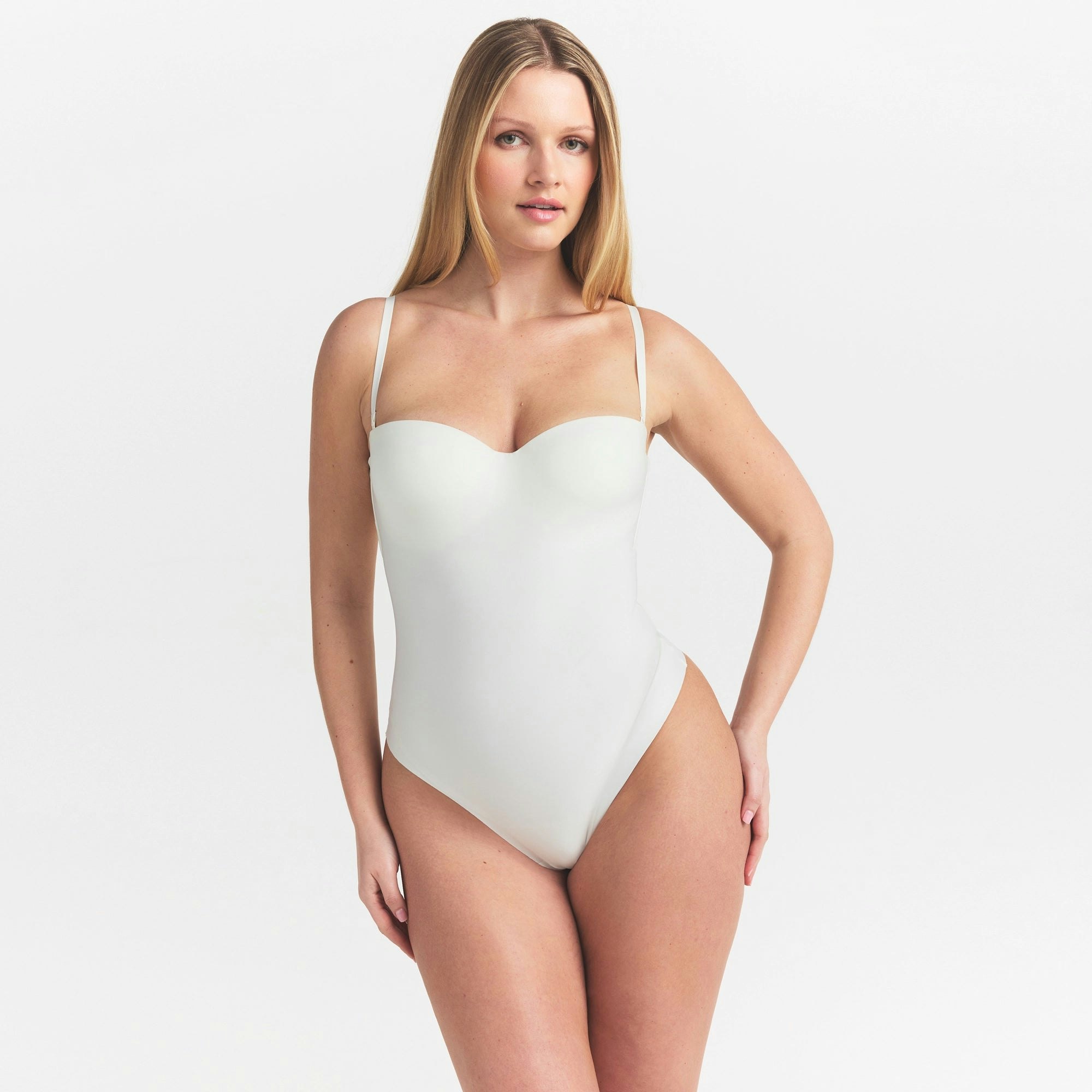 SKIMS BODY UNDERWIRE THONG BODYSUIT | IVORY ON A MODEL SIDE VIEW @ | FOCUS: 0.0, 1.0, 0.9