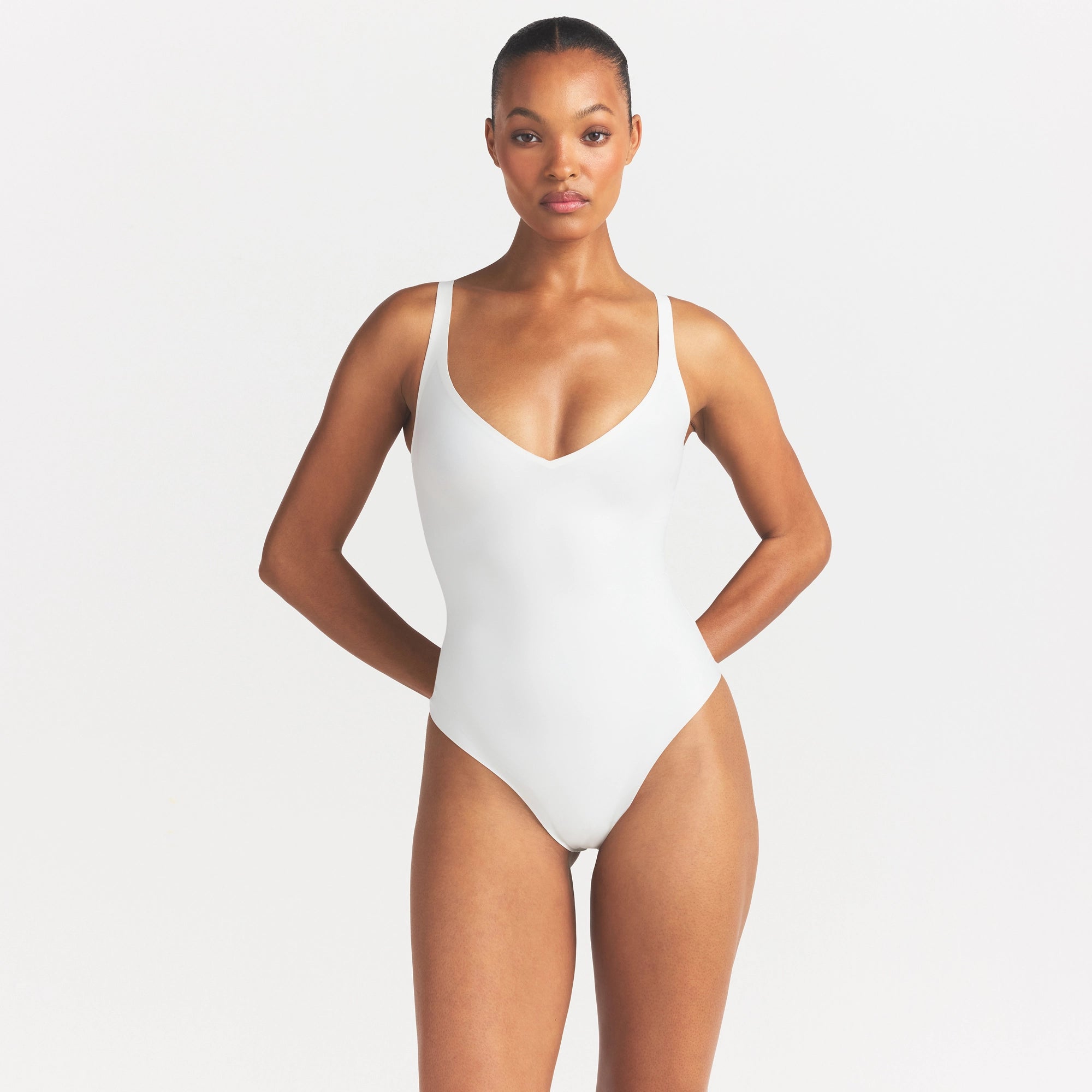 SKIMS BODY UNLINED PLUNGE THONG BODYSUIT | IVORY ON A MODEL SIDE VIEW @ | FOCUS: 0.0, 1.0, 0.9