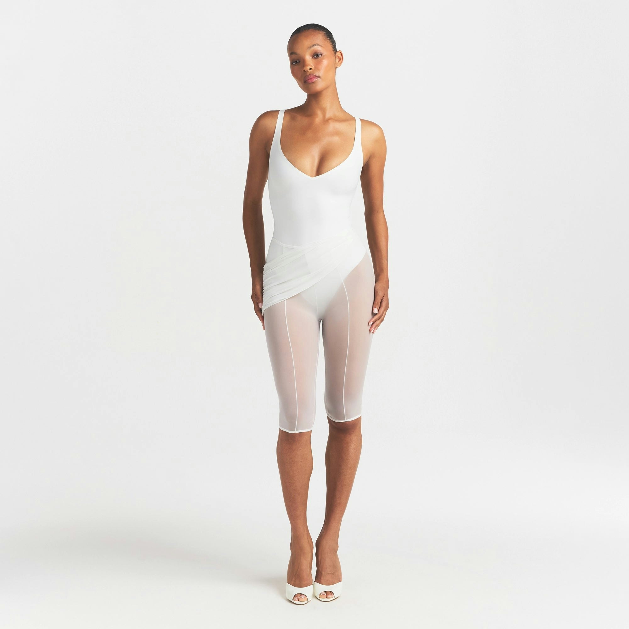 SKIMS BODY UNLINED PLUNGE THONG BODYSUIT | IVORY ON A MODEL FRONT VIEW @ | FOCUS: 0.0, 1.0, 0.9