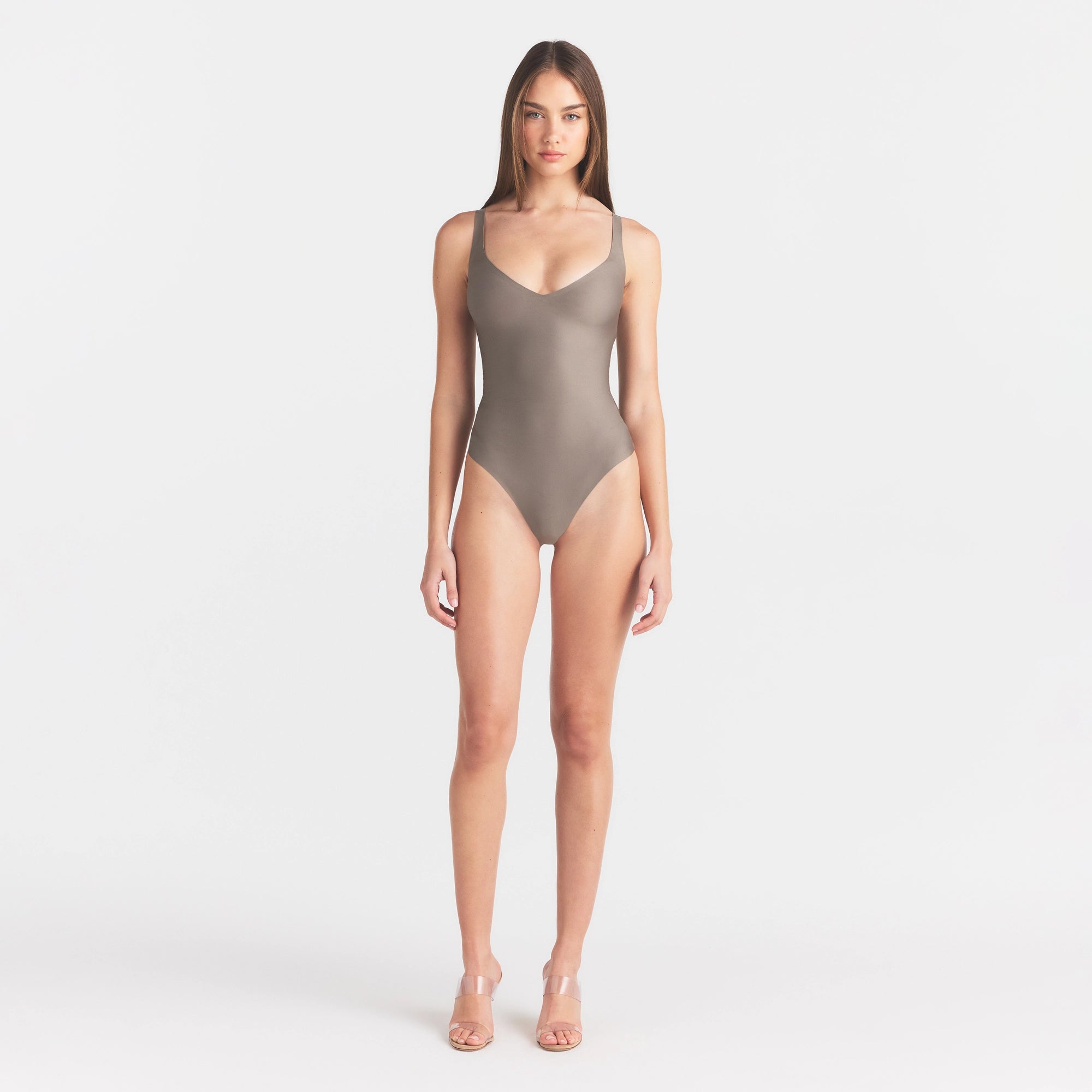 SKIMS BODY UNLINED PLUNGE THONG BODYSUIT | MINK ON A MODEL FRONT VIEW @ | FOCUS: 0.0, 1.0, 0.9