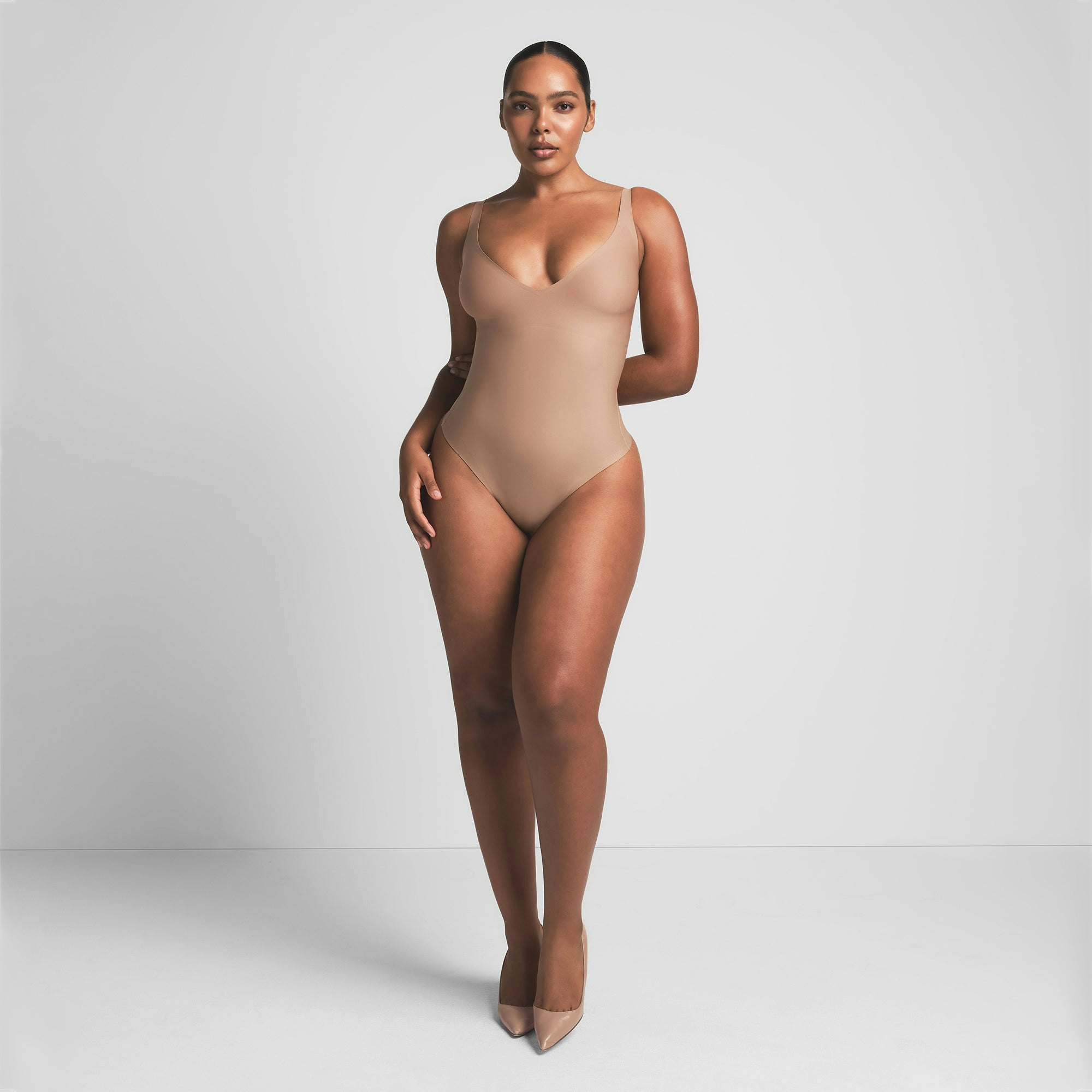 SKIMS BODY CORE SCULPT PLUNGE THONG BODYSUIT | SIENNA ON A MODEL FRONT VIEW | FOCUS: 0.0, 1.0, 0.9