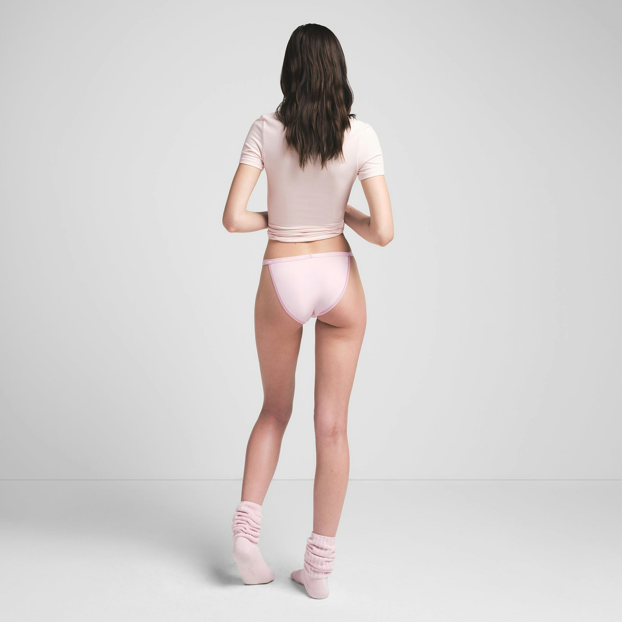 LIGHTWEIGHT COTTON PICOT LOGO STRING BIKINI | CHERRY BLOSSOM ON A MODEL BACK VIEW @ | FOCUS: 0.0, 1.0, 0.9