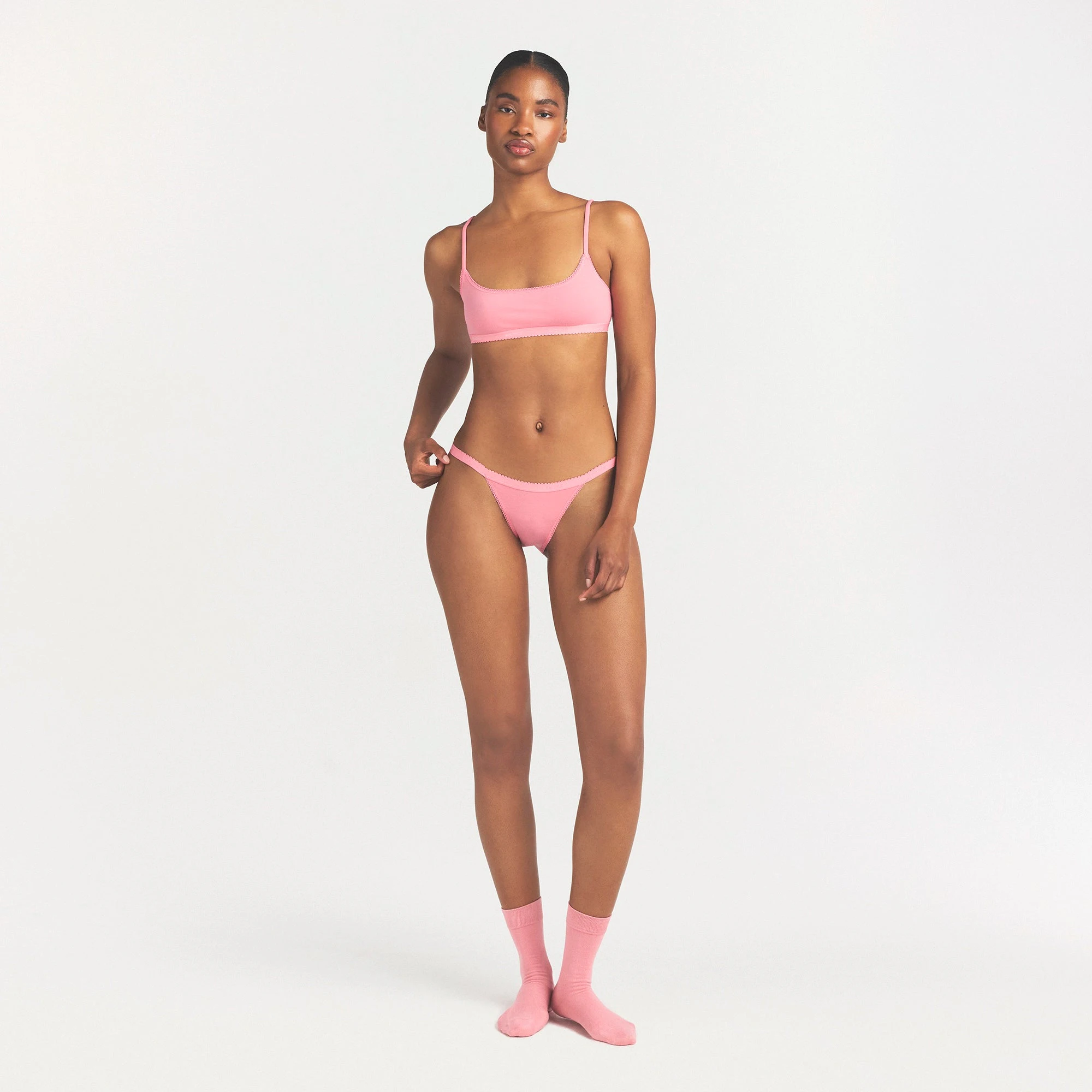 LIGHTWEIGHT COTTON LOGO PICOT STRING BIKINI | MELON TONAL ON A MODEL FRONT VIEW @ | FOCUS: 0.0, 1.0, 0.9