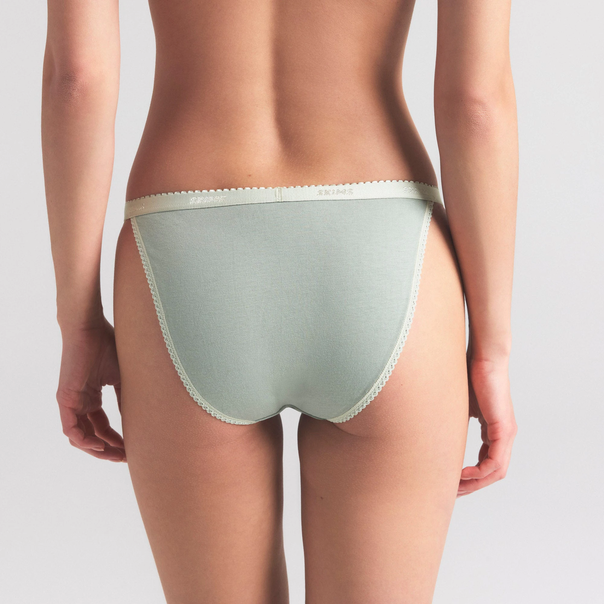 LIGHTWEIGHT COTTON LOGO PICOT STRING BIKINI | MINERAL ON A MODEL SIDE VIEW | FOCUS: 0.0, 1.0, 0.9