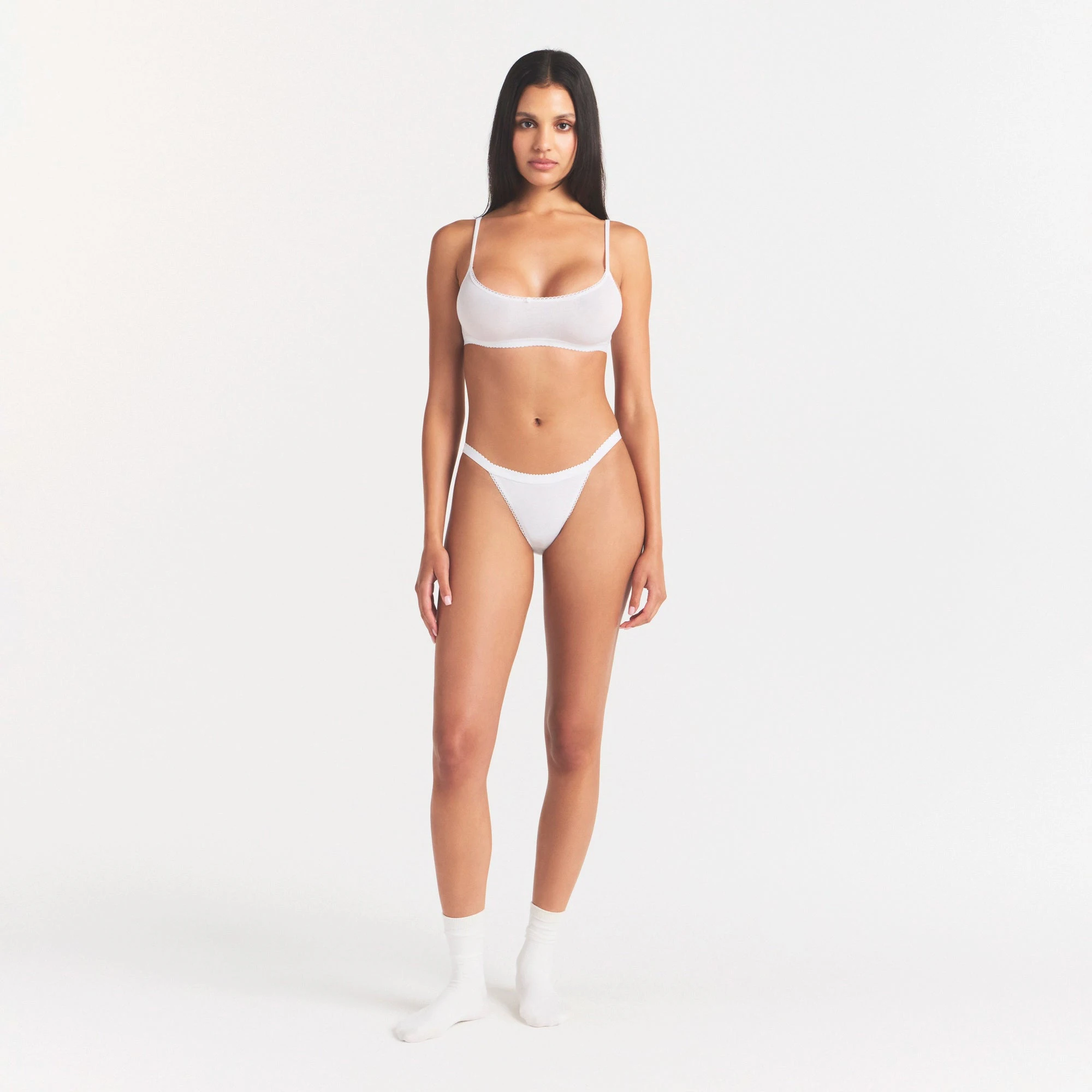 LIGHTWEIGHT COTTON LOGO PICOT STRING BIKINI | SNOW ON A MODEL FRONT VIEW | FOCUS: 0.0, 1.0, 0.9