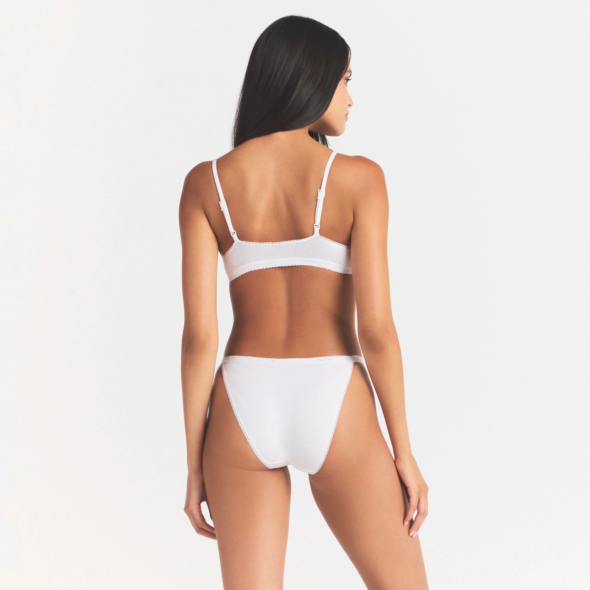 LIGHTWEIGHT COTTON LOGO PICOT STRING BIKINI | SNOW ON A MODEL SIDE VIEW | FOCUS: 0.0, 1.0, 0.9