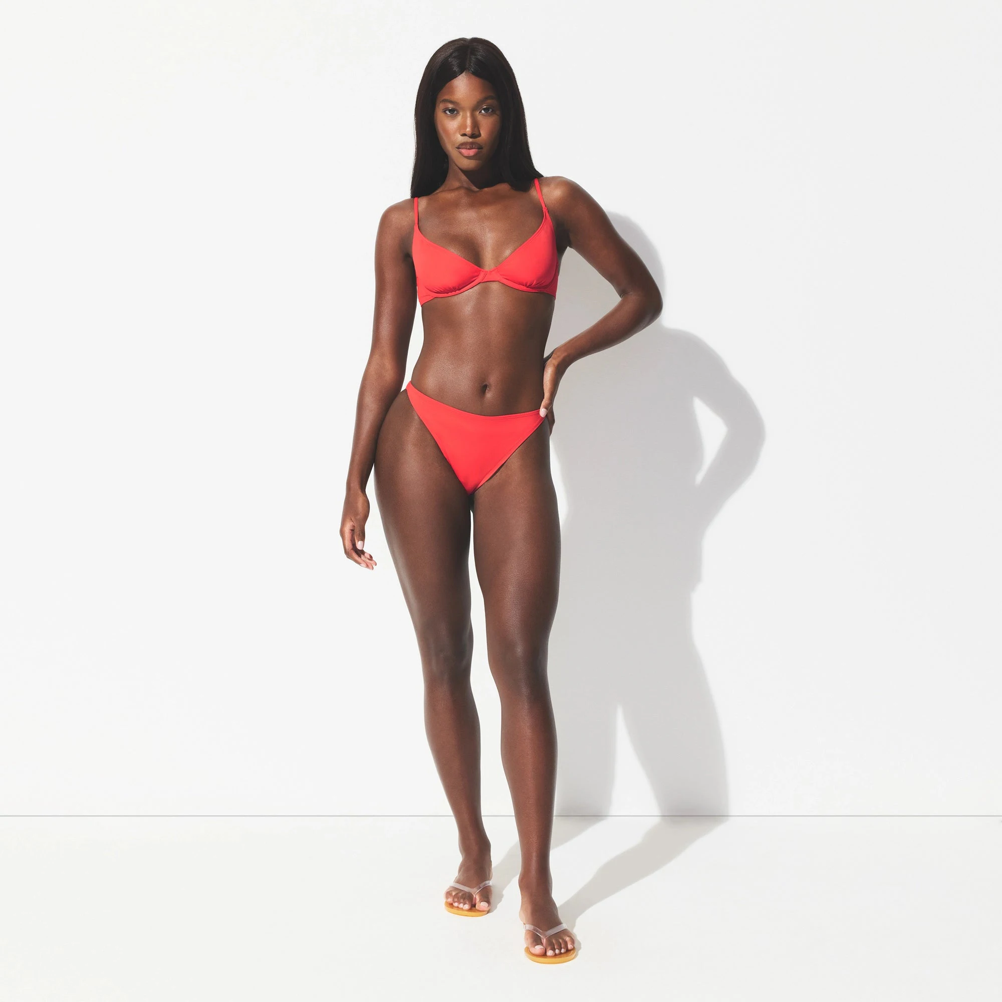 ICONIC SWIM HIGH LEG BIKINI BOTTOM | CARMINE ON A MODEL FRONT VIEW @ | FOCUS: 0.0, 1.0, 0.9