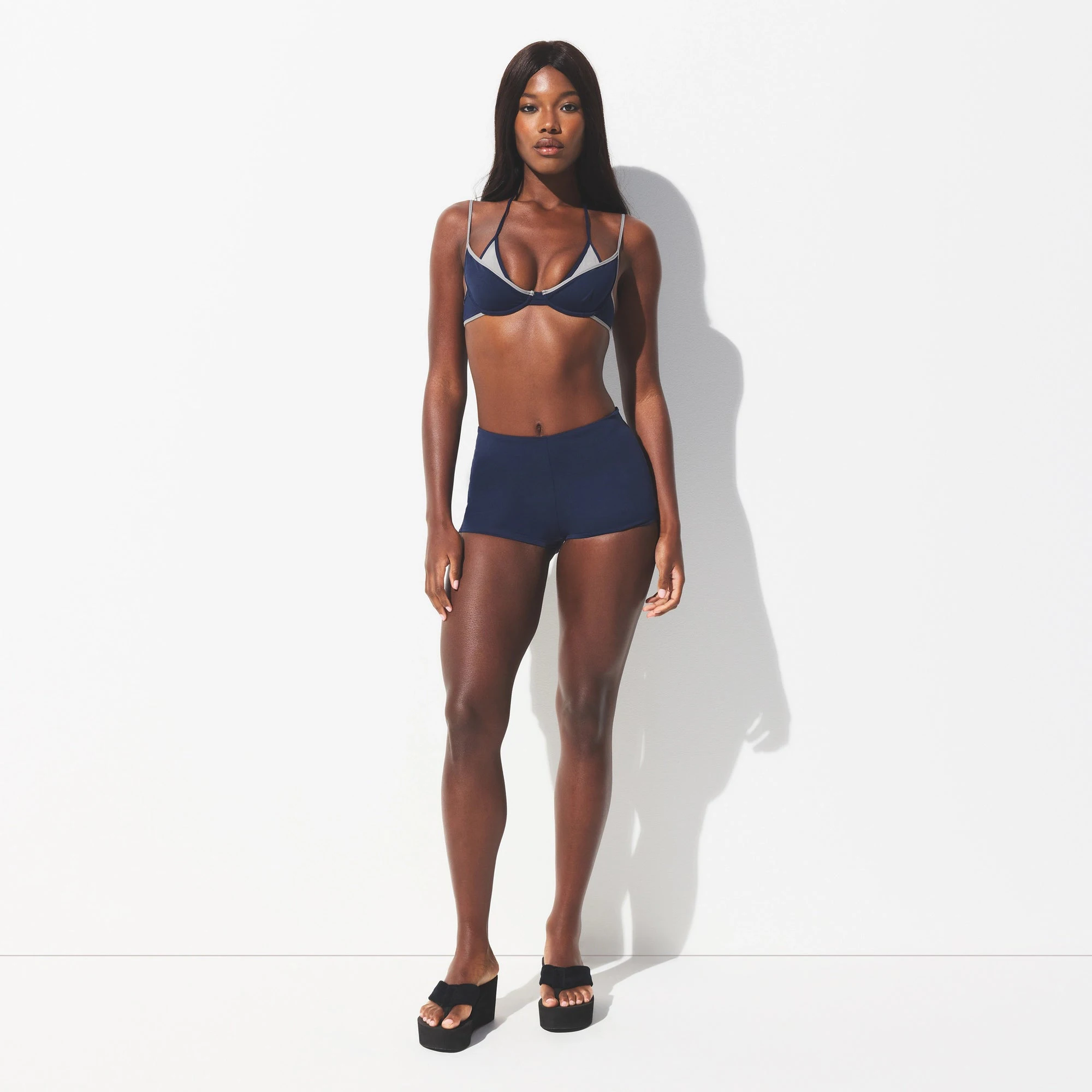 SIGNATURE SWIM SHORT BIKINI BOTTOM | NAVY ON A MODEL FRONT VIEW @ | FOCUS: 0.0, 1.0, 0.9