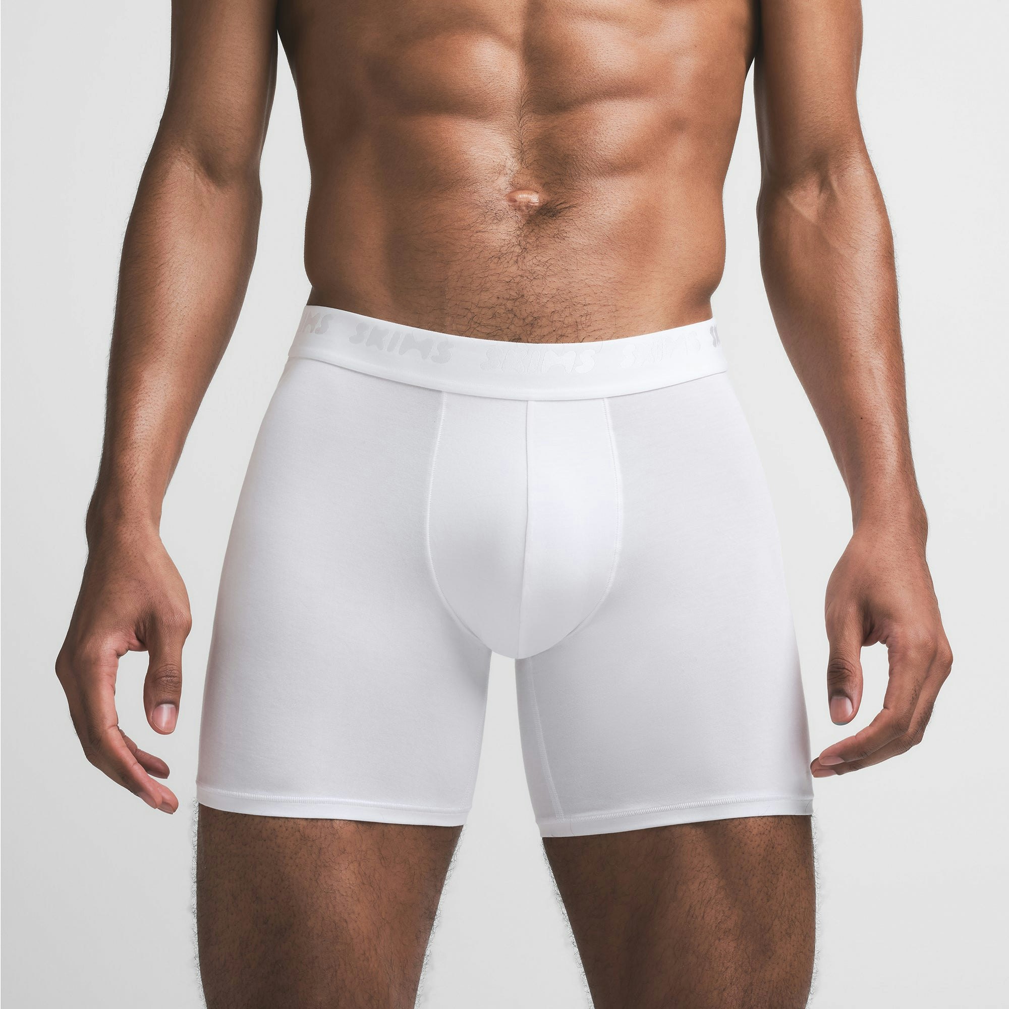 SKIMS STRETCH MENS 5" BOXER BRIEF | CHALK ON A MODEL FRONT VIEW @ | FOCUS: 0.9, 0.1, 0.7