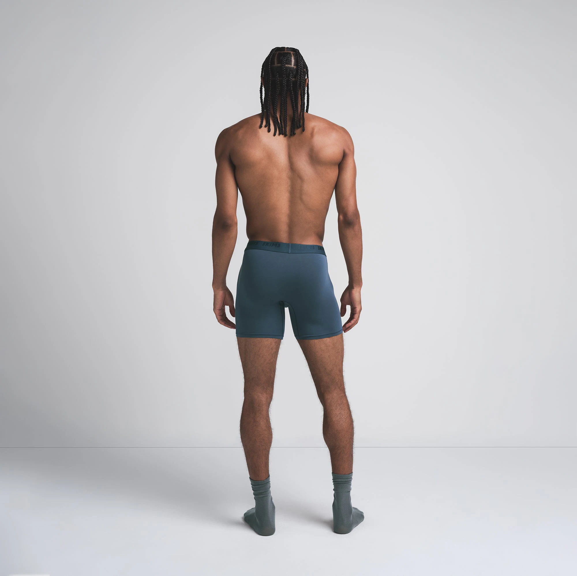 SKIMS STRETCH MENS 5 INCH BOXER BRIEF | INDIGO ON A MODEL BACK VIEW