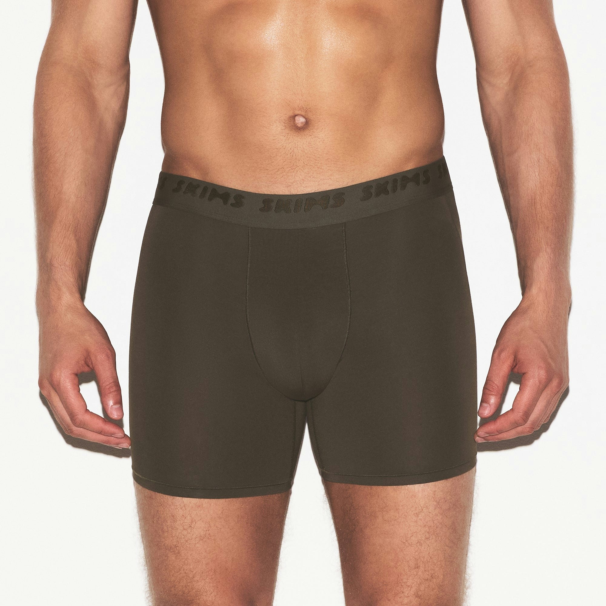SKIMS STRETCH MENS 5 INCH BOXER BRIEF | LODEN ON A MODEL SIDE VIEW @ | FOCUS: 0.0, 1.0, 0.9