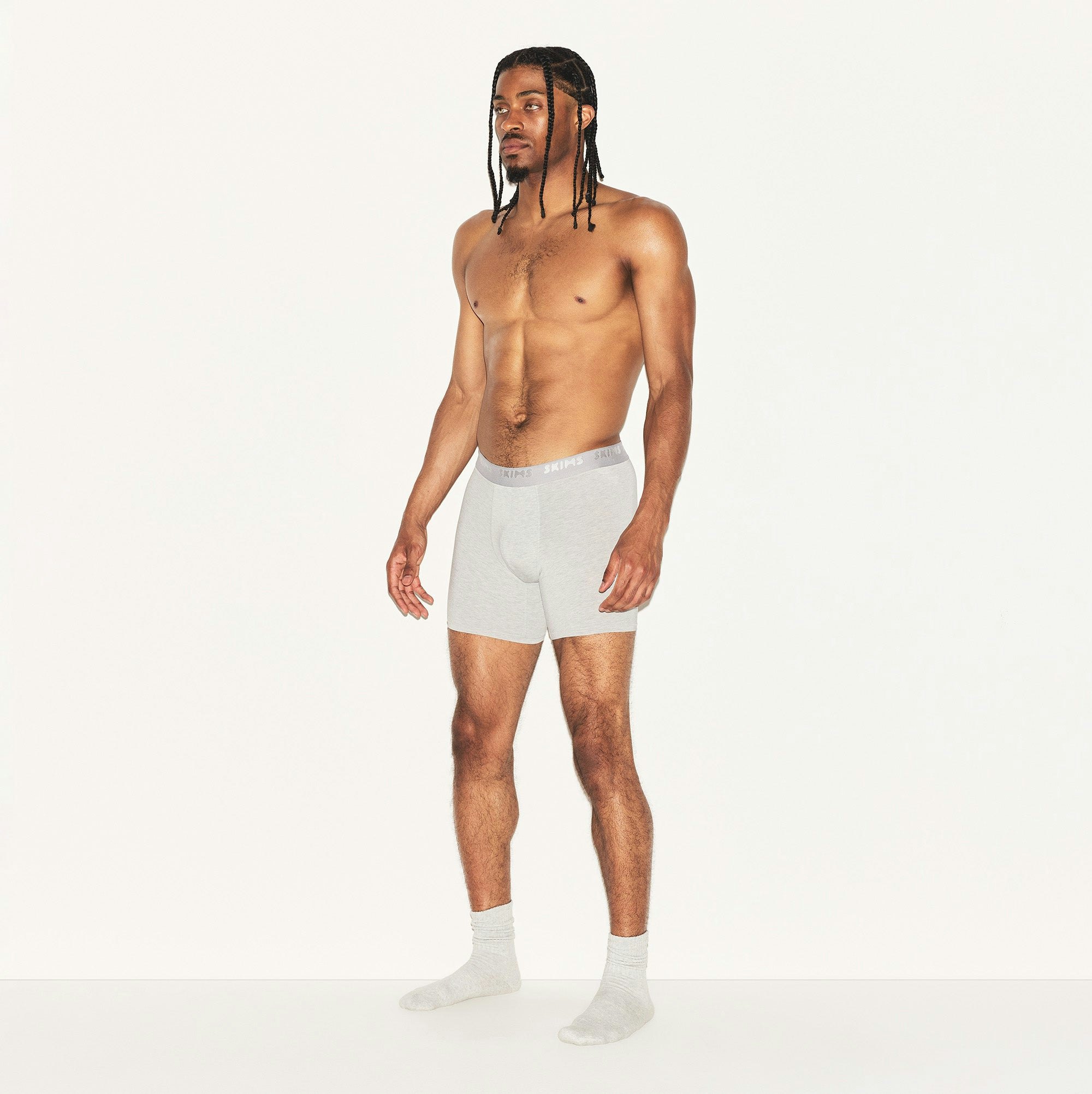 SKIMS STRETCH MENS 5" BOXER BRIEF | LIGHT HEATHER GREY ON A MODEL SIDE VIEW | FOCUS: 0.0, 1.0, 0.9
