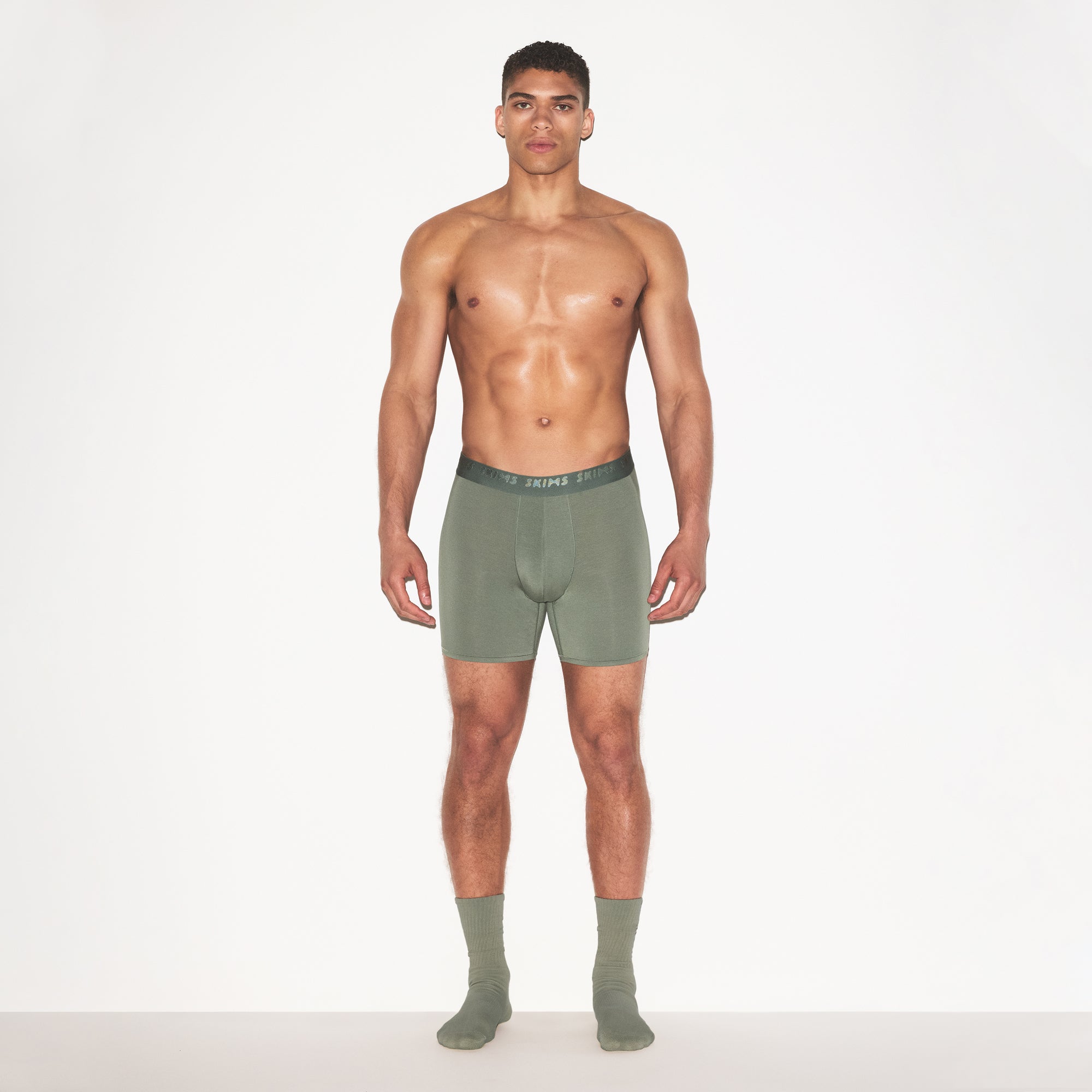 SKIMS STRETCH MENS 5" BOXER BRIEF | LAUREL ON A MODEL FRONT VIEW | FOCUS: 0.0, 1.0, 0.9