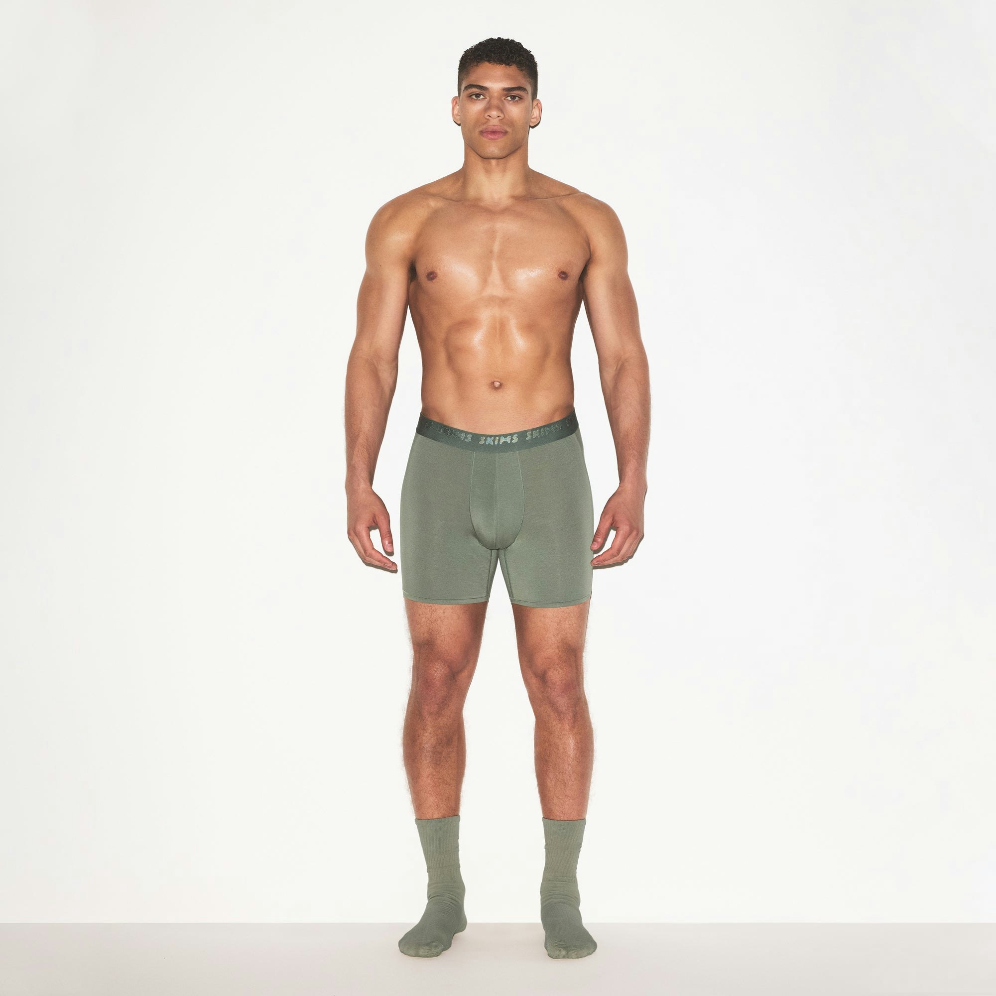 SKIMS STRETCH MENS 5" BOXER BRIEF | LAUREL ON A MODEL FRONT VIEW | FOCUS: 0.0, 1.0, 0.9