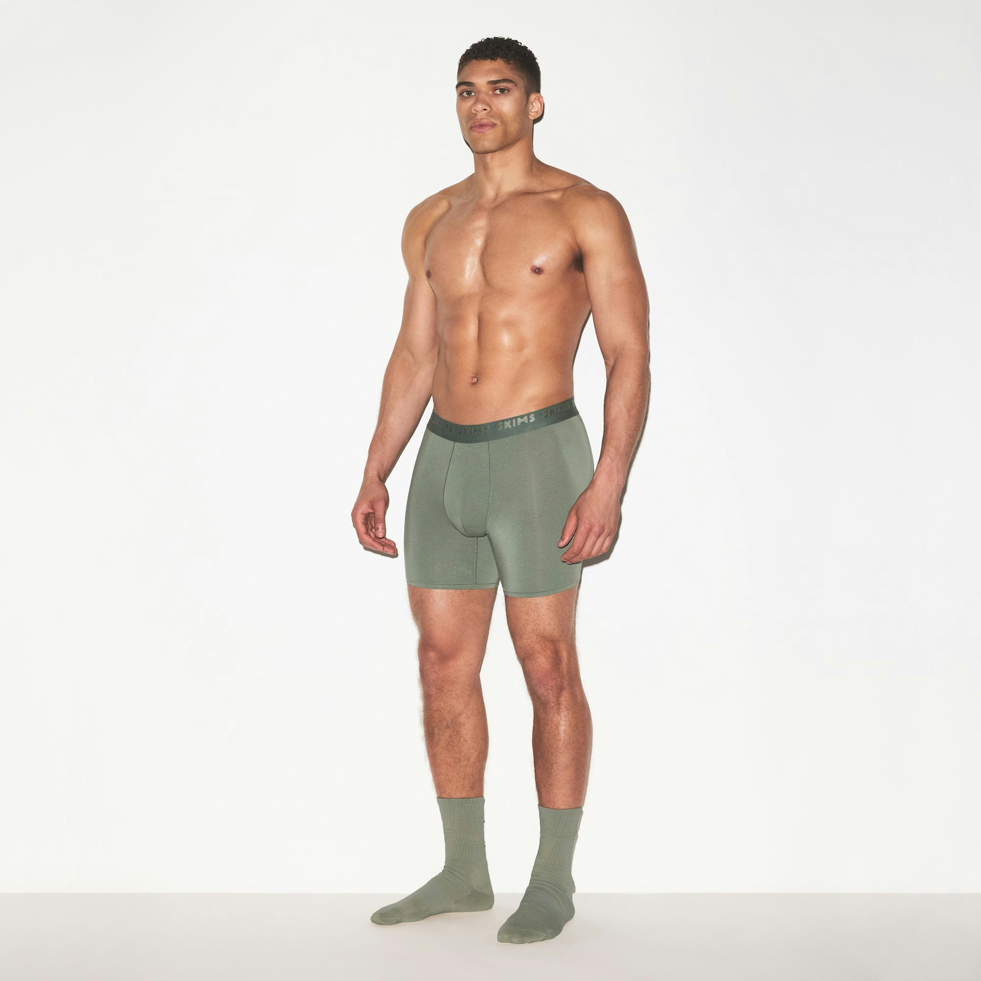 SKIMS STRETCH MENS 5 INCH BOXER BRIEF | LAUREL ON A MODEL FRONT VIEW | FOCUS: 0.0, 1.0, 0.9