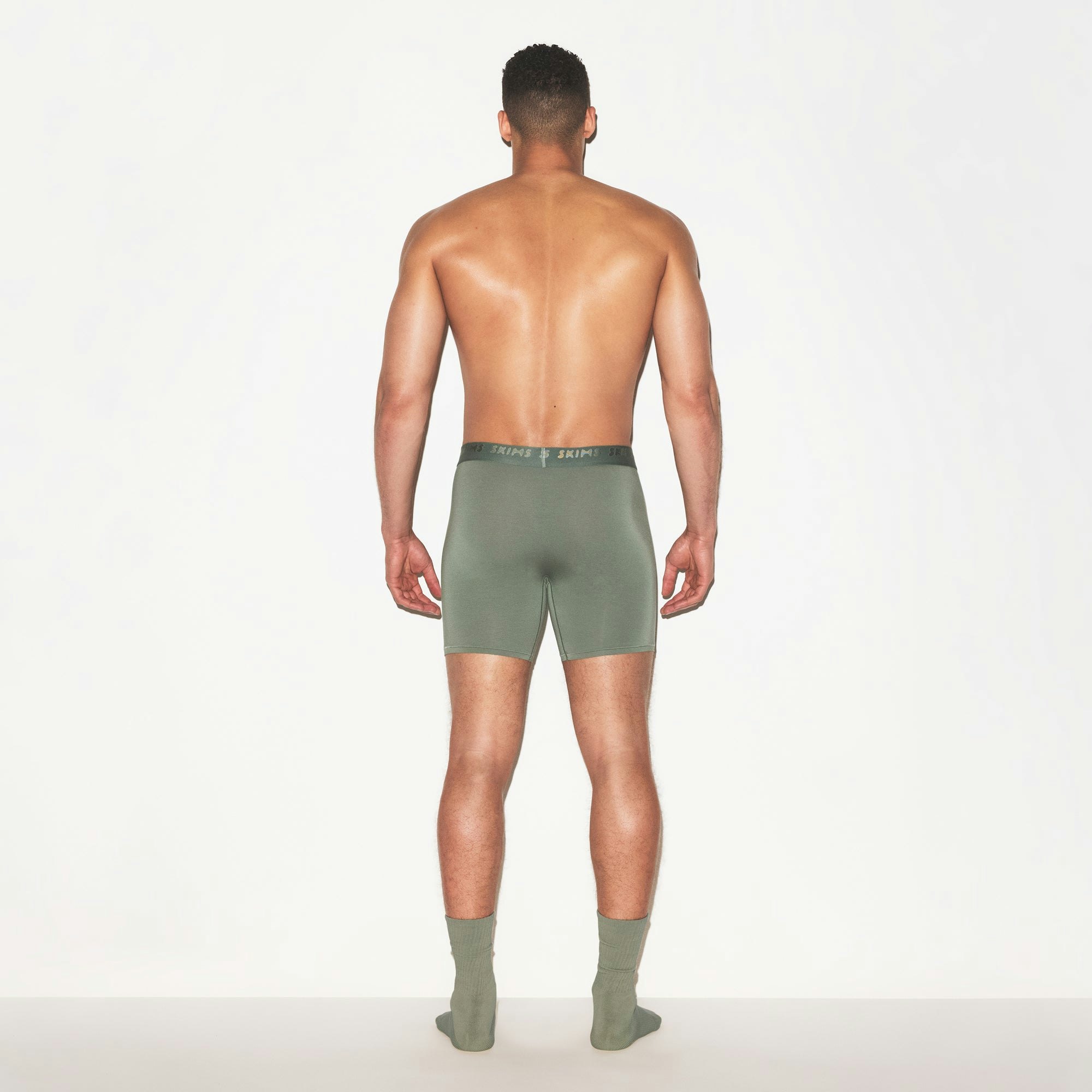 SKIMS STRETCH MENS 5 INCH BOXER BRIEF | LAUREL ON A MODEL FRONT VIEW | FOCUS: 0.0, 1.0, 0.9