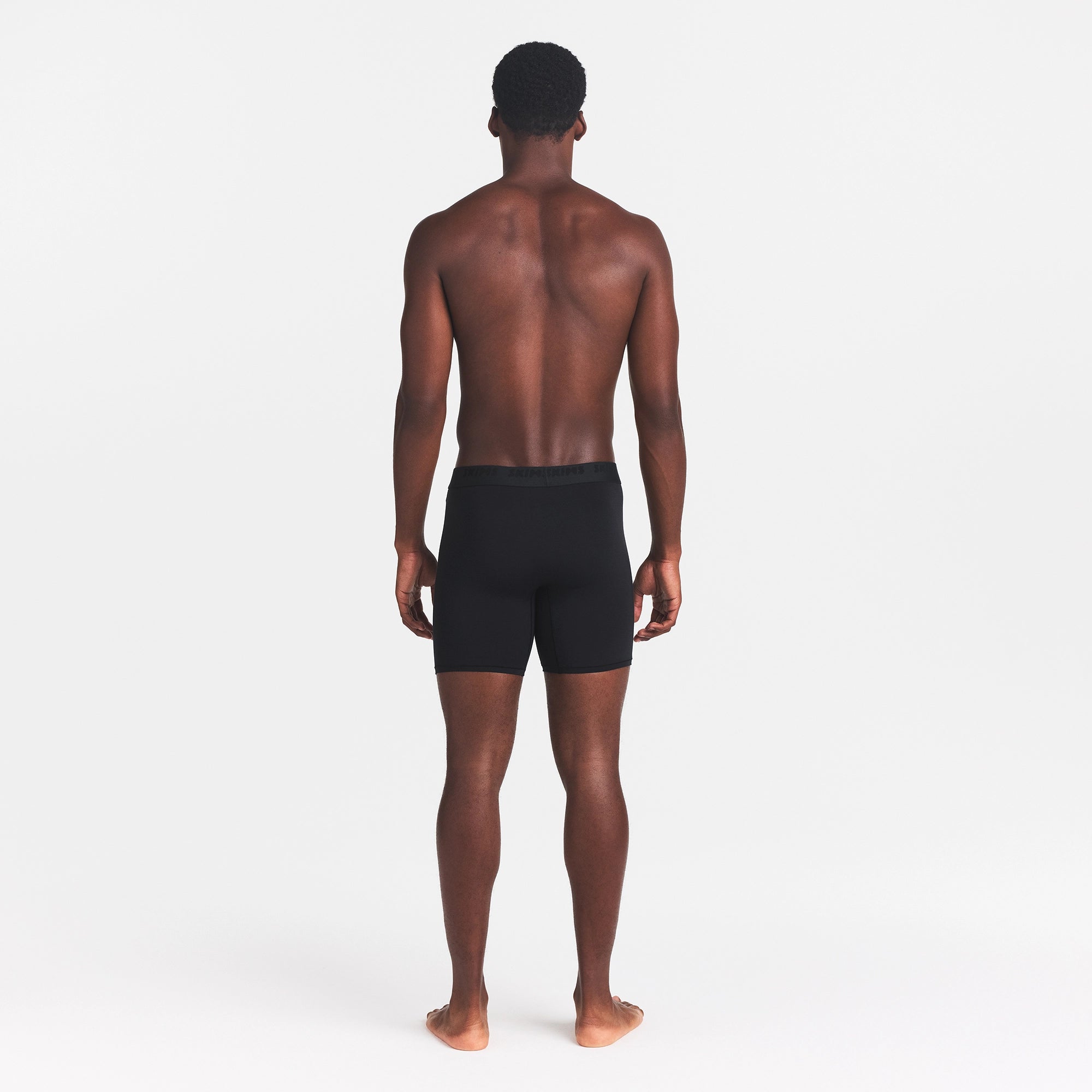 SKIMS STRETCH MENS 5" BOXER BRIEF | OBSIDIAN ON A MODEL BACK VIEW