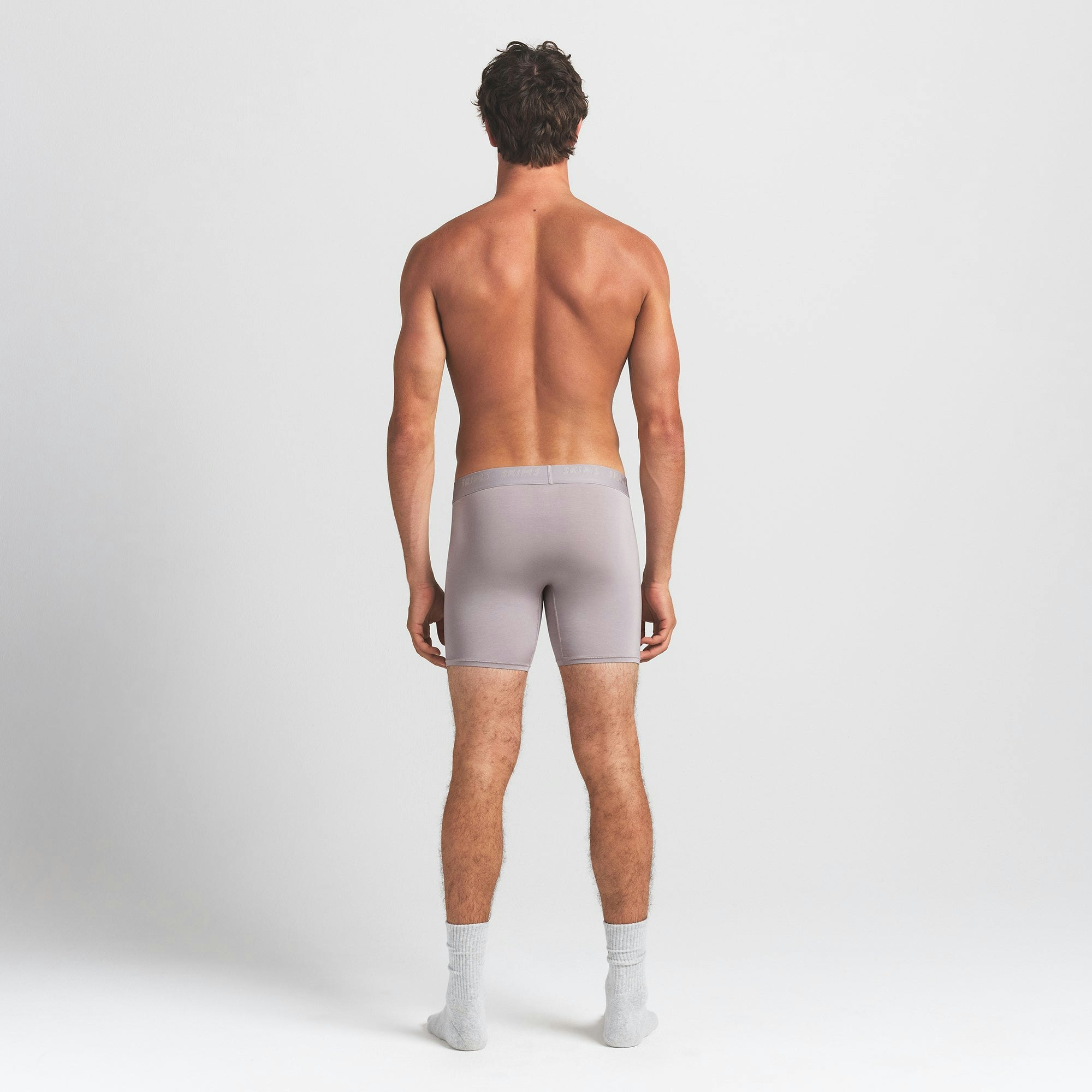 SKIMS STRETCH MENS 5" BOXER BRIEF | OYSTER ON A MODEL BACK VIEW @ | FOCUS: 0.0, 1.0, 0.9