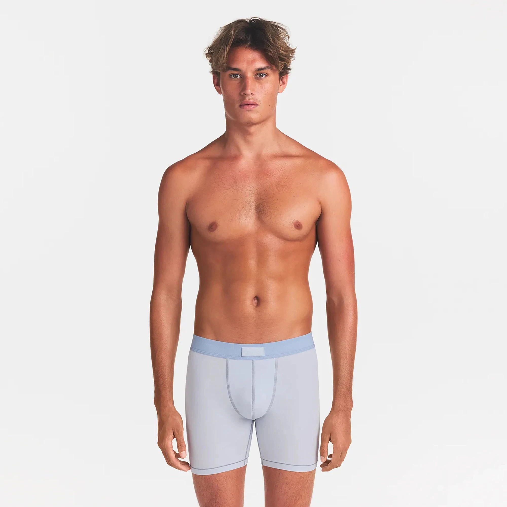 SKIMS COTTON MENS 5" BOXER BRIEF | ATMOSPHERE ON A MODEL FRONT VIEW