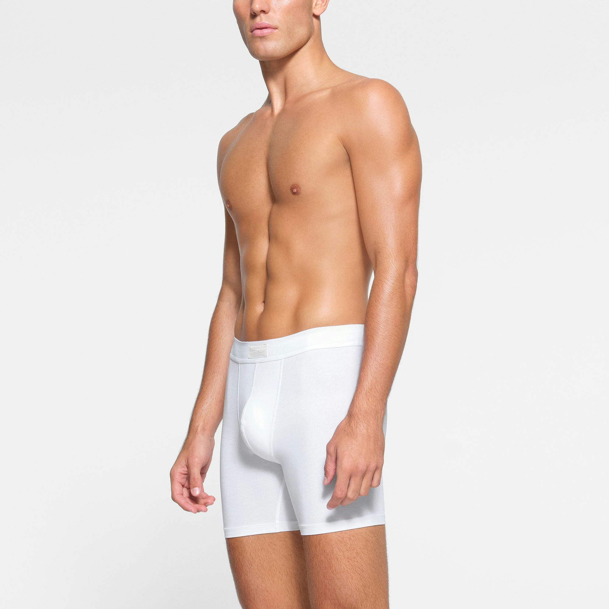 SKIMS COTTON MENS 5" BOXER BRIEF 3-PACK WORN BY A MODEL IN SIDE VIEW