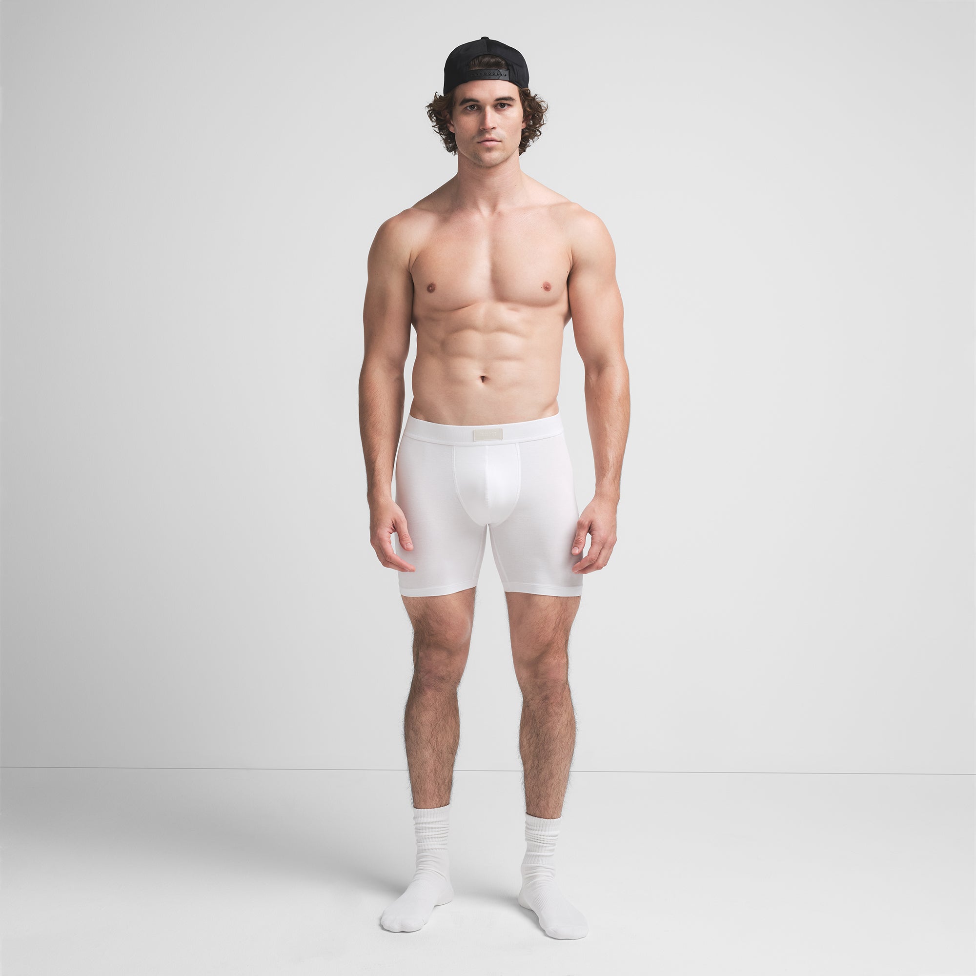 SKIMS COTTON MENS 5" BOXER BRIEF | CHALK ON A MODEL FRONT VIEW @ | FOCUS: 0.9, 0.1, 0.7