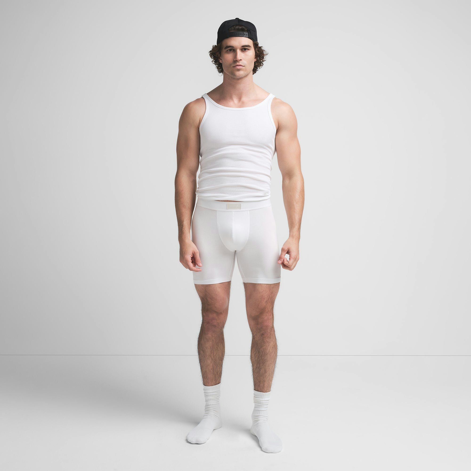 SKIMS COTTON MENS 5" BOXER BRIEF | CHALK ON A MODEL FRONT VIEW @ | FOCUS: 0.9, 0.1, 0.7