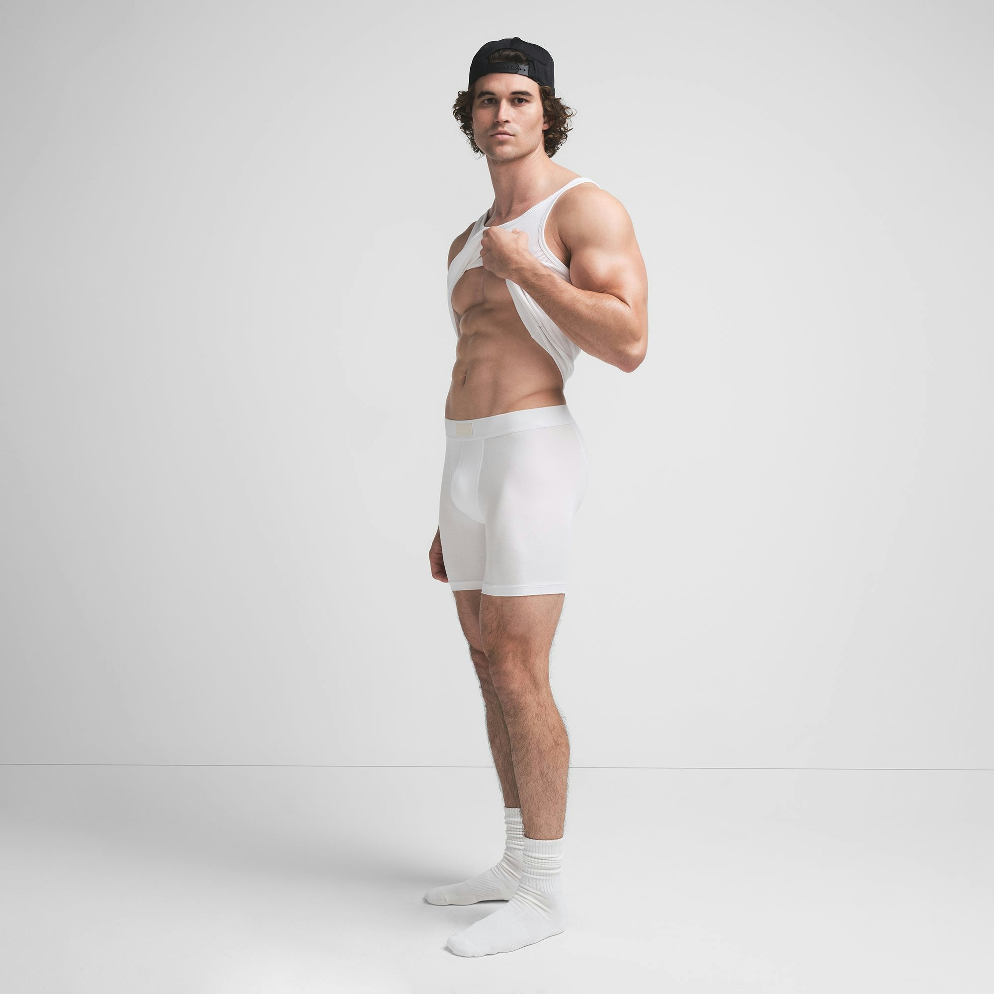 SKIMS COTTON MENS 5" BOXER BRIEF | CHALK ON A MODEL SIDE VIEW @ | FOCUS: 0.9, 0.1, 0.7