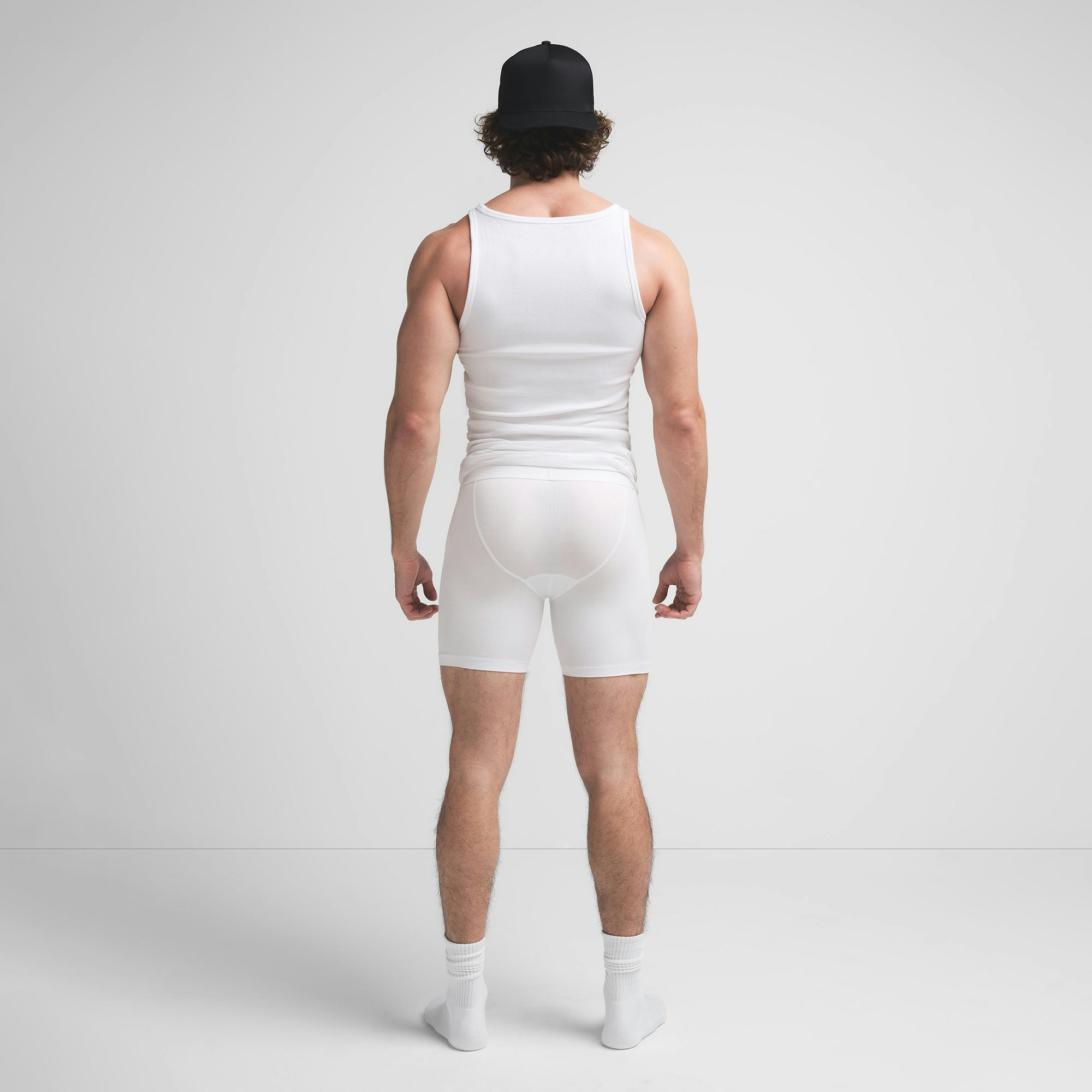 SKIMS COTTON MENS 5" BOXER BRIEF | CHALK ON A MODEL BACK VIEW @ | FOCUS: 0.9, 0.1, 0.7