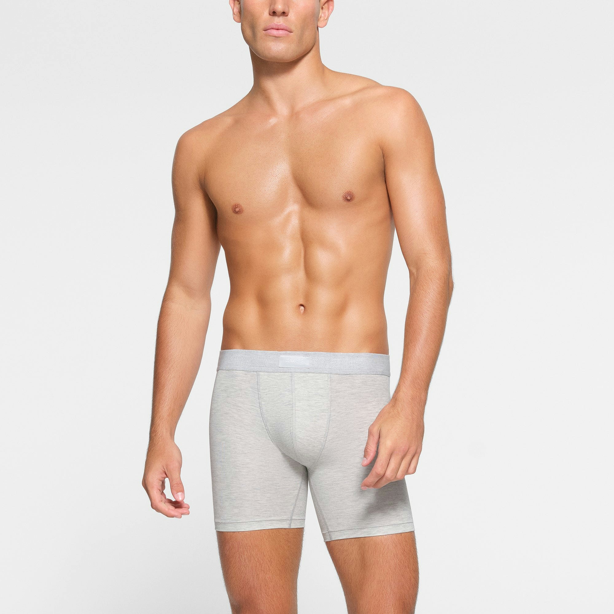 SKIMS COTTON MENS 5" BOXER BRIEF 3-PACK WORN BY A MODEL IN FRONT VIEW