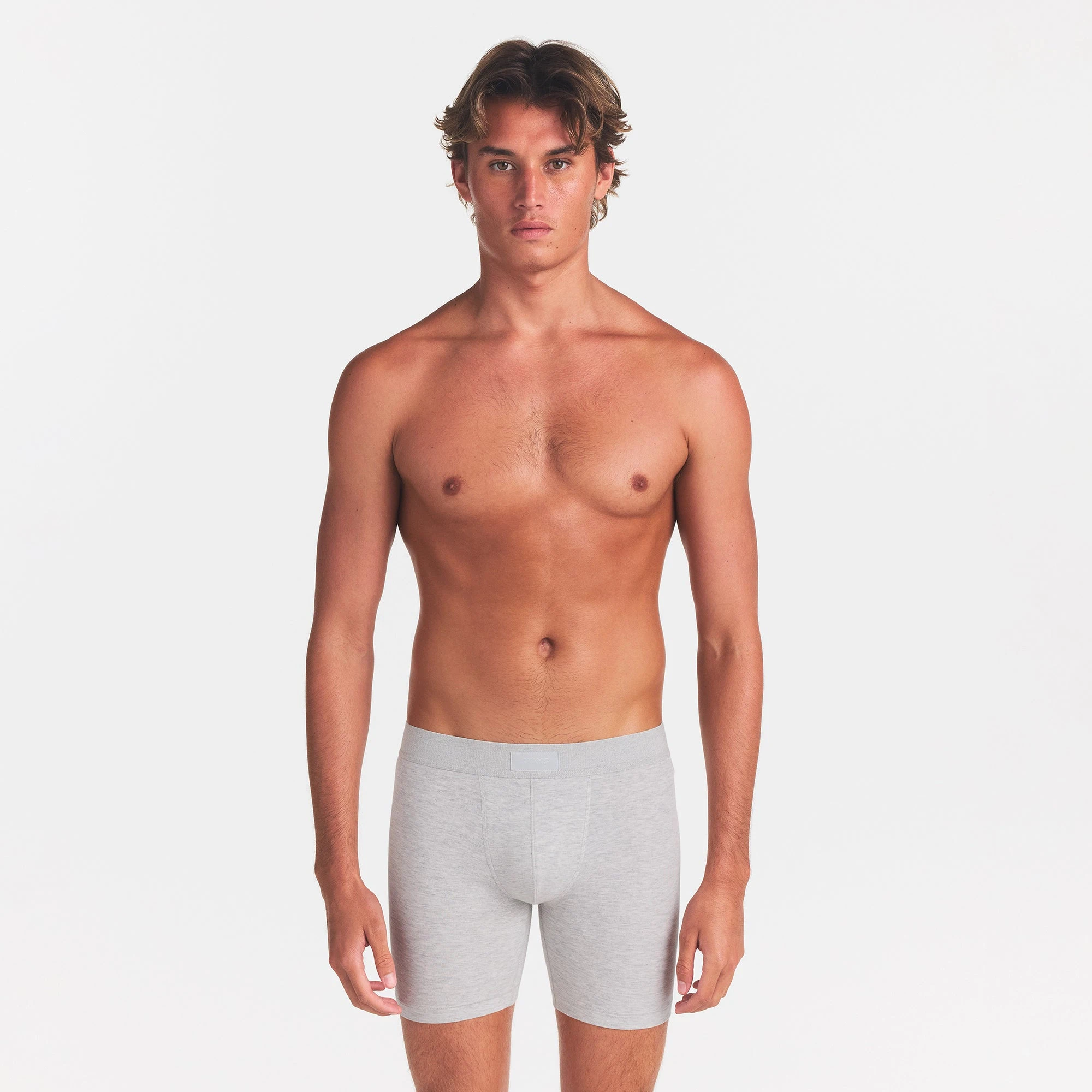 SKIMS COTTON MENS 5" BOXER BRIEF | LIGHT HEATHER GREY ON A MODEL FRONT VIEW