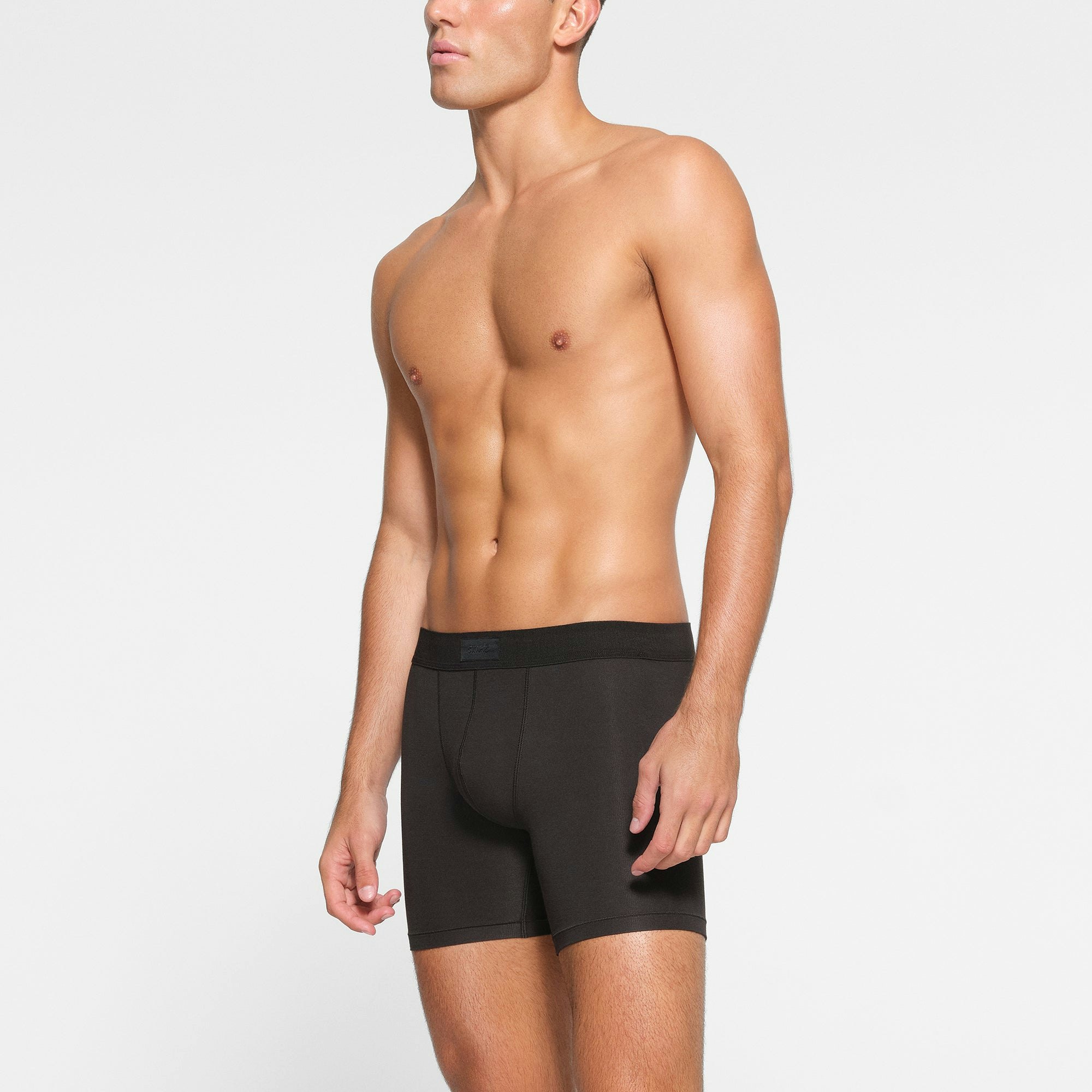 SKIMS COTTON MENS 5" BOXER BRIEF 3-PACK WORN BY A MODEL IN SIDE VIEW
