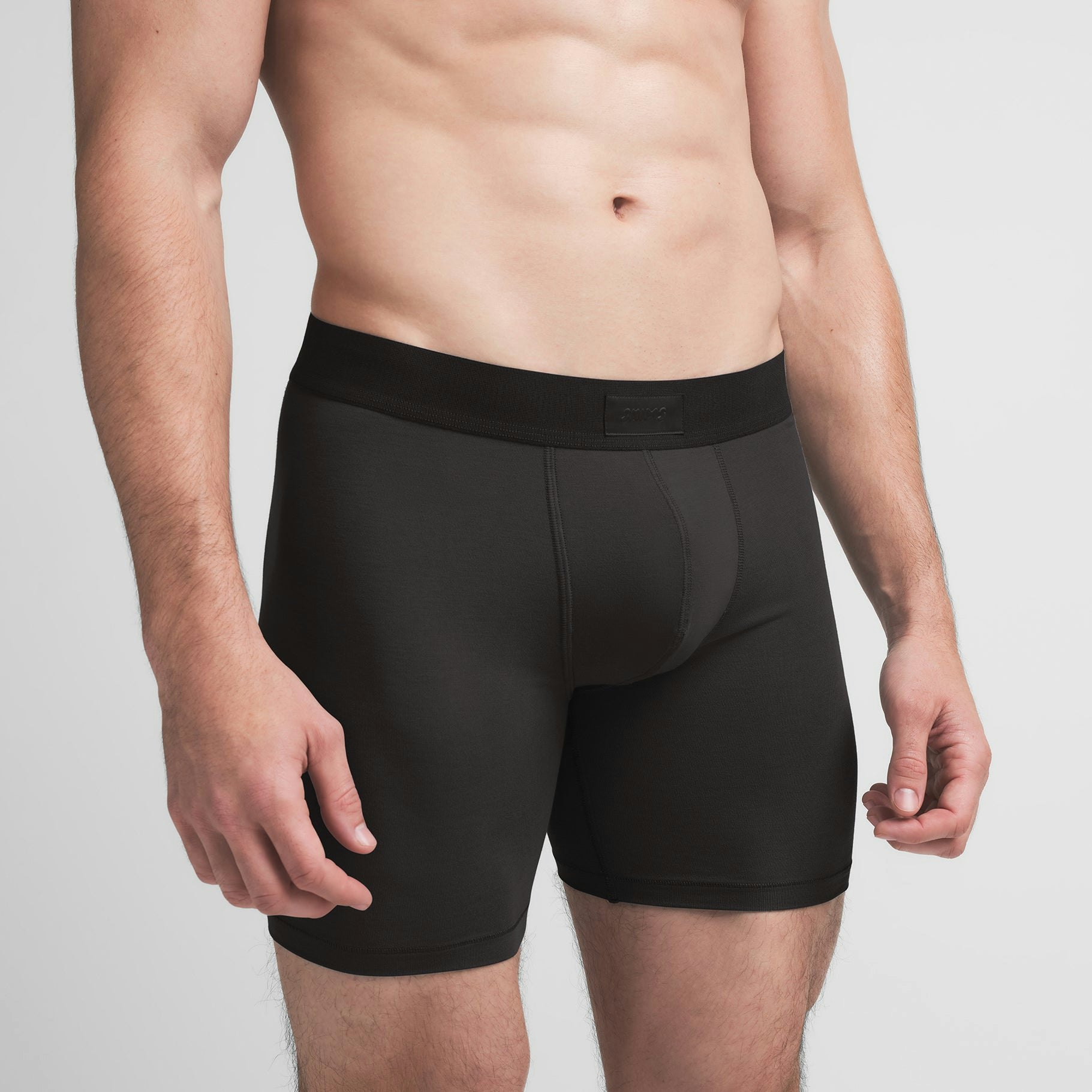 SKIMS COTTON MENS 5" BOXER BRIEF | ONYX ON A MODEL SIDE VIEW @ | FOCUS: 0.9, 0.1, 0.7