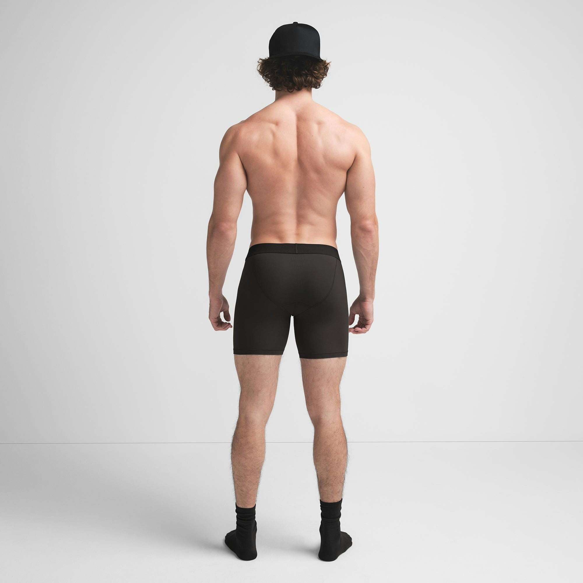 SKIMS COTTON MENS 5" BOXER BRIEF | ONYX ON A MODEL BACK VIEW @ | FOCUS: 0.9, 0.1, 0.7
