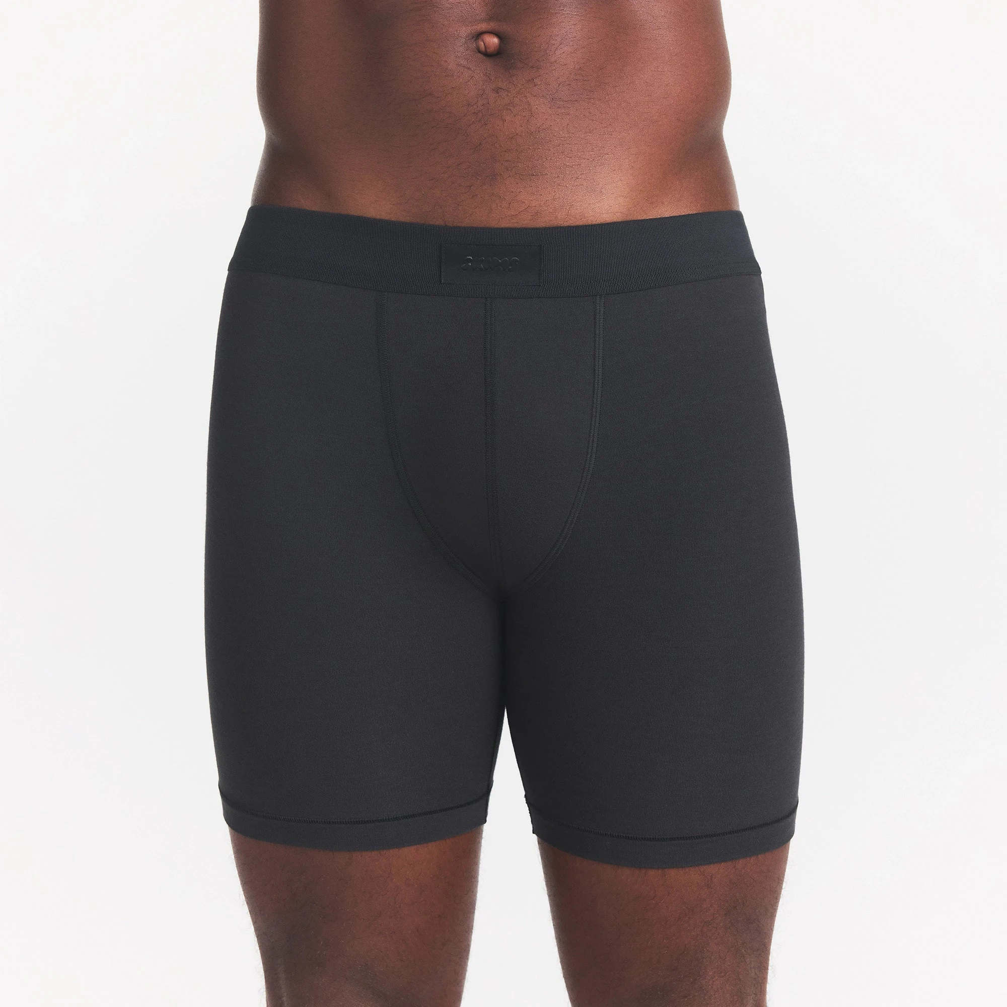 SKIMS COTTON MENS 5" BOXER BRIEF | ONYX ON A MODEL FRONT VIEW