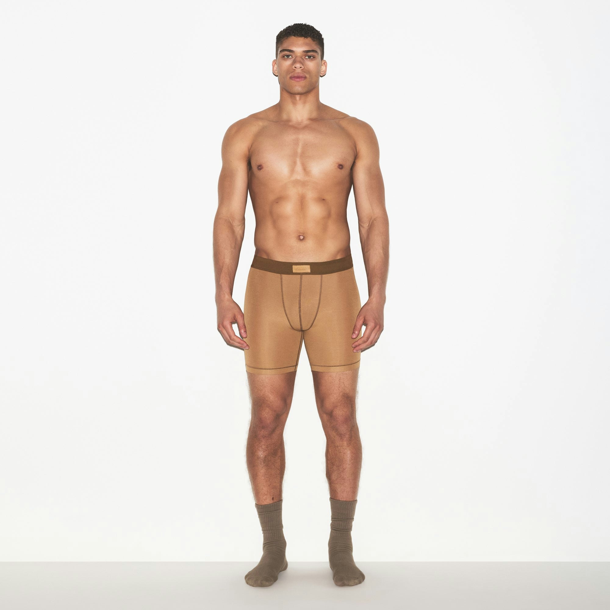 SKIMS COTTON MENS 5 INCH BOXER BRIEF | RUSSET ON A MODEL FRONT VIEW | FOCUS: 0.0, 1.0, 0.9